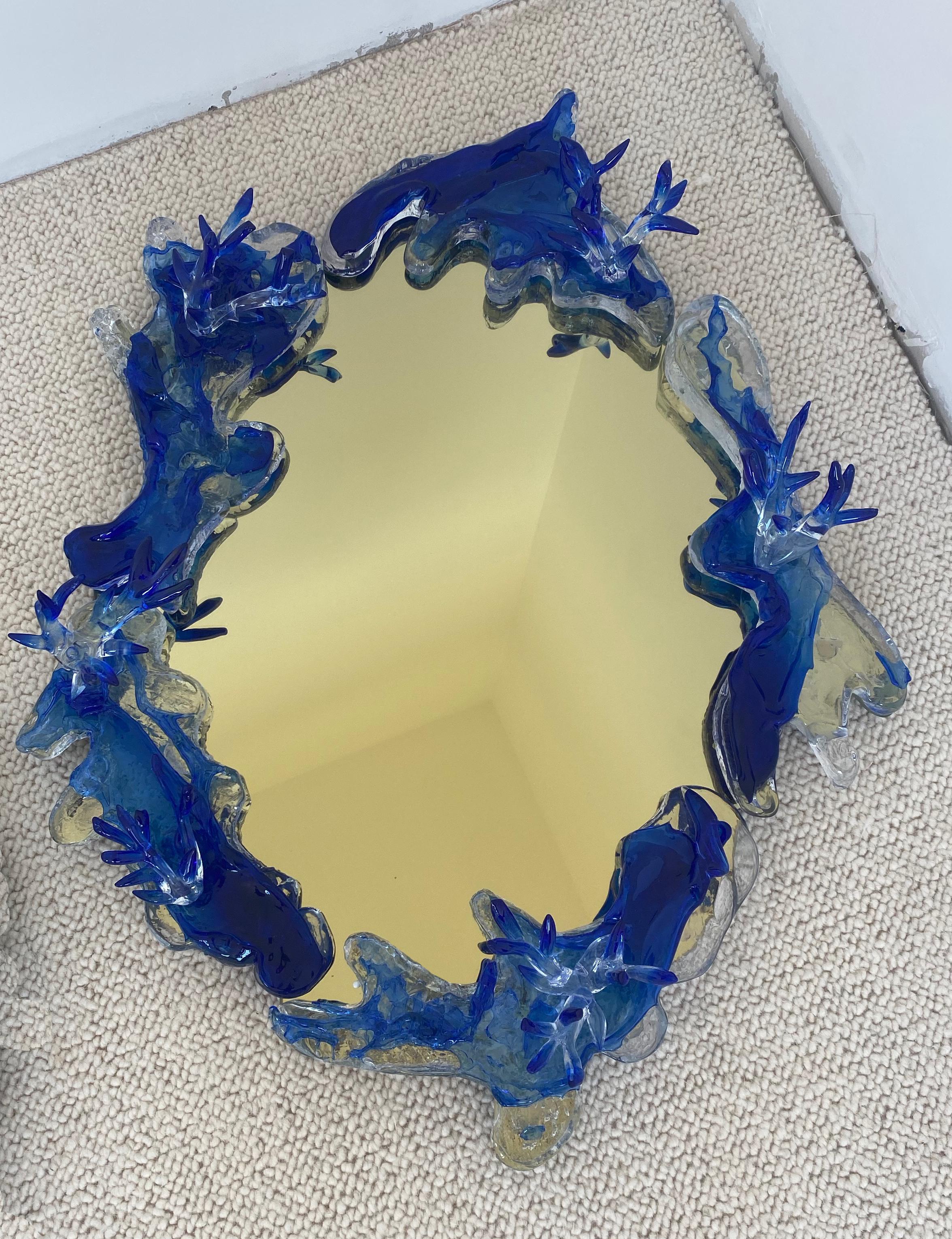 Light Gold Mirror With Ultramarine Blue Decor by Emilie Lemardeley
Dimensions: D 17 x W 57 x H 70 cm.
Materials: Glass and mirror.

Designed as jewellery for the interior, the Lemardeley’s creations reflect French craftsmanship infused with elegance