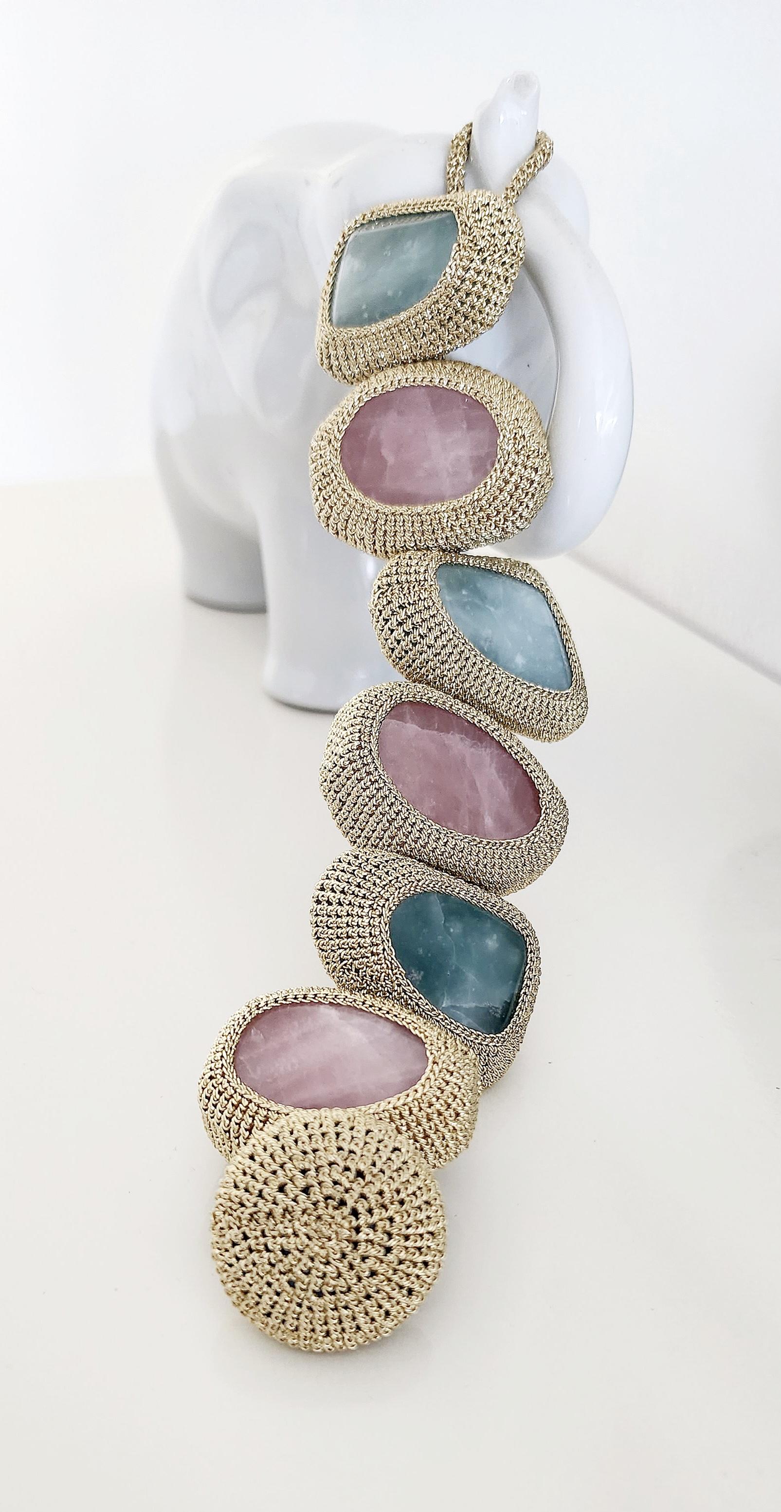 This is a wonderful statement bracelet. It evokes the feeling of spring with its pastel colored stones. The thread is a smooth passing light golden thread with no metal content. The stones are beautiful large polished Amazonites and Rose Quartz.