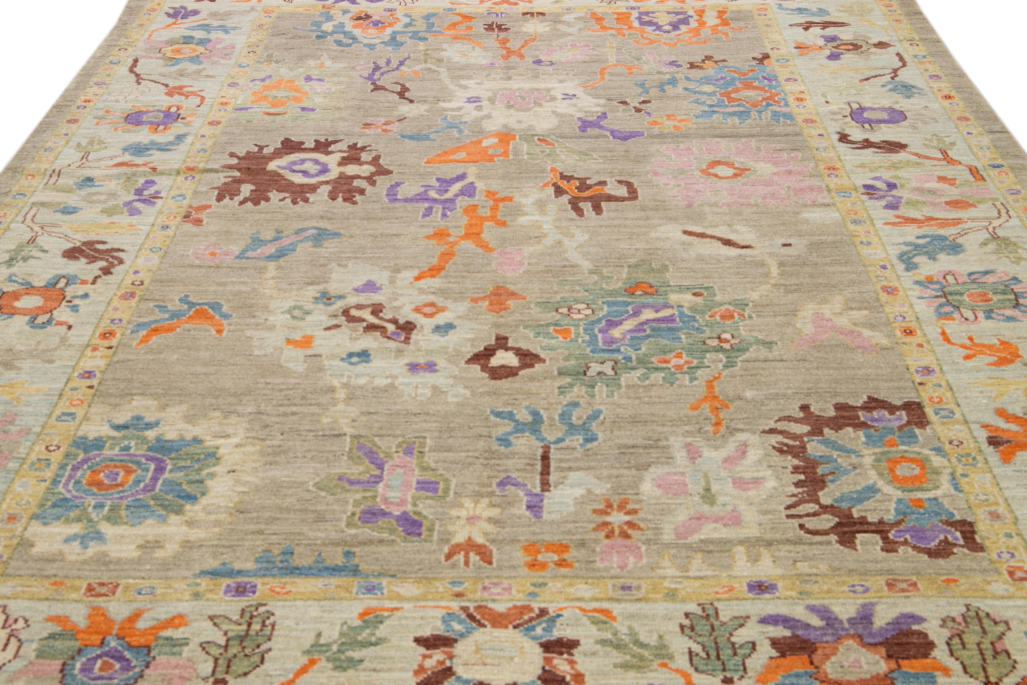 This hand-knotted wool rug highlights a modern take on the timeless Sultanabad design. It boasts a breathtaking light gray shade that radiates charm and elegance. The mesmerizing floral embroidery, featuring a range of vibrant colors, is beautifully