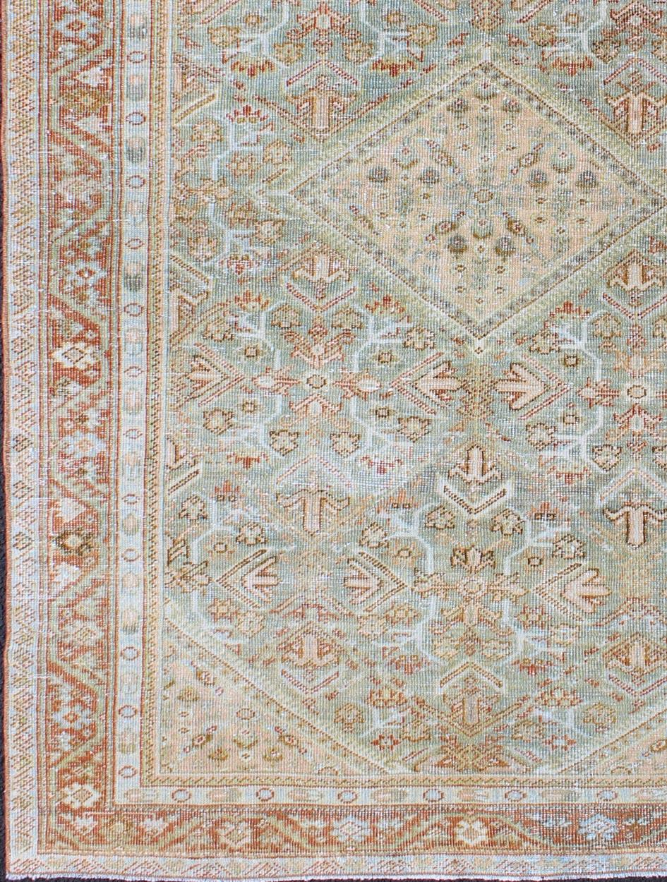 Persian Mahal antique rug with floral design in Peach, green, blue, and red colors with central Medallion, rug na-180709, country of origin / type: Iran / Mahal, circa 1920.

This antique Persian Mahal rug, circa early 20th century, relies heavily