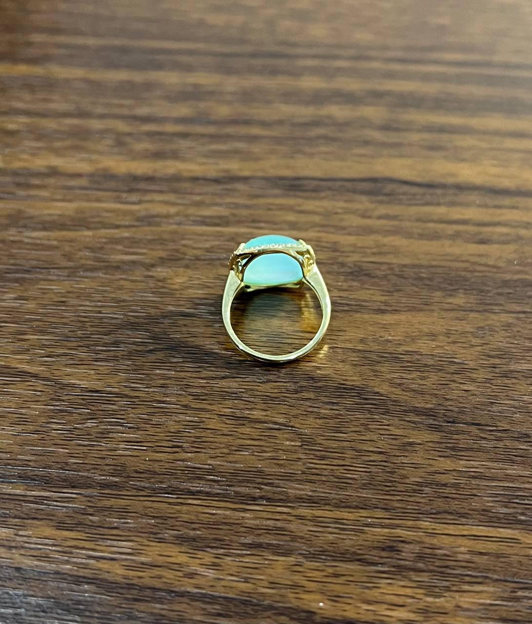 Gold Ring with Blue Stone, crafted in the 21st century, features a primary carat weight of 12.31 and is made in 14k gold.

This ring showcases a captivating blue stone with a smooth, polished surface, set in a delicate gold band.

The stone is