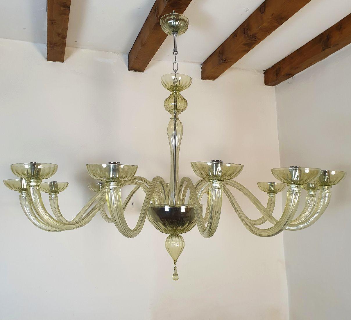 Extra large Murano glass chandelier, attributed to Venini, Italy 1970s.
The Mid Century Modern chandelier is handmade, in a light transparent green Murano glass.
It has chrome mounts.
The chandelier has 12 lights / arms.
It has been rewired for