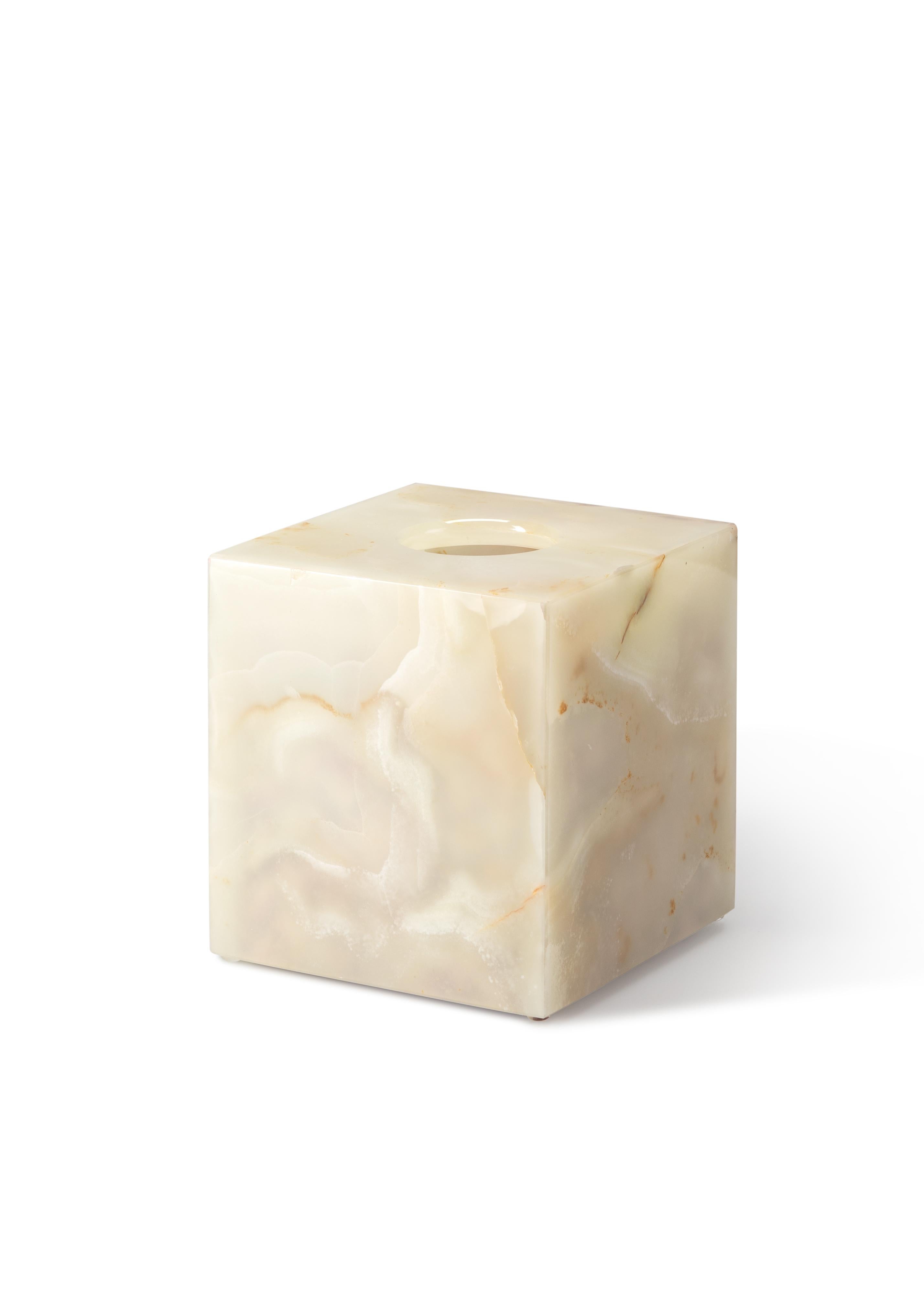 Crafted entirely by hand, this onyx tissue box cover is a fusion of form and function, seamlessly blending into any space while adding sophistication and elegance. Clean, minimalist lines highlight the natural veining of the marble, making each