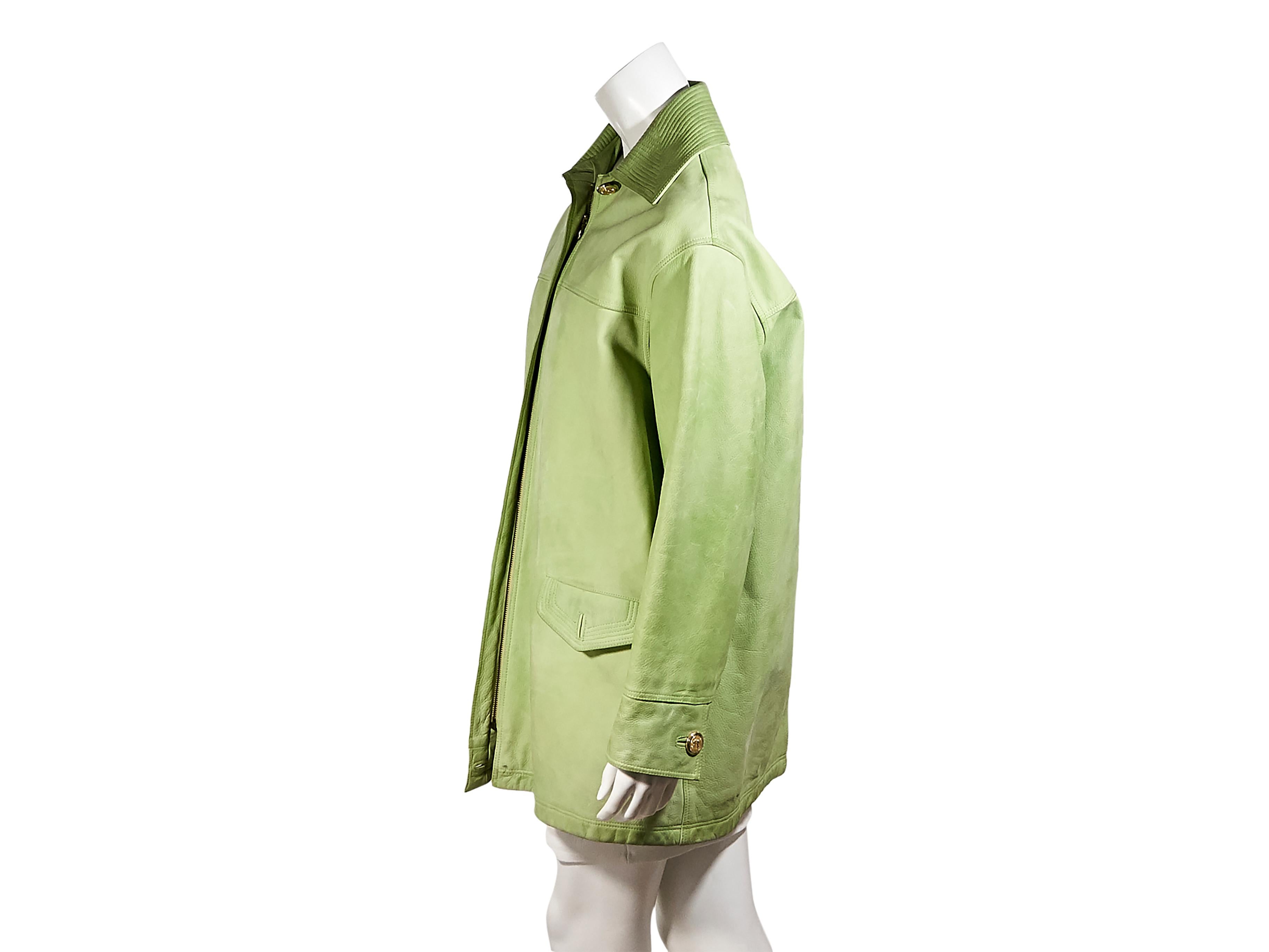 Product details:  Vintage light green leather coat by Versus Gianni Versace.  Spread collar.  Long sleeves.  Concealed zip-front closure.  Waist flap pockets.  Goldtone hardware.  Label size IT 42.  40