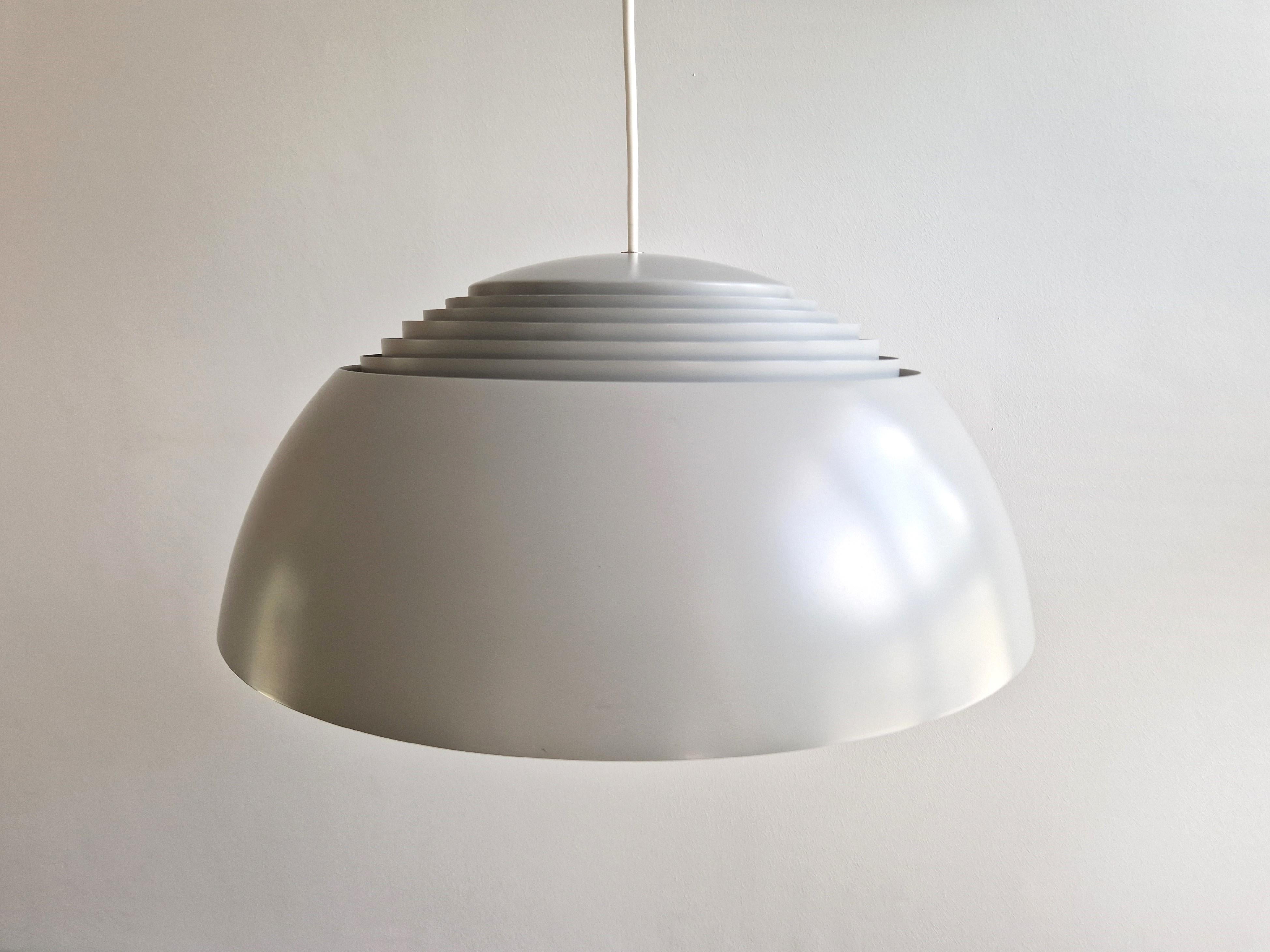 The iconic AJ Royal pendant lamp by Louis Poulsen is a design by the well-known Danish architect Arne Jacobsen from 1958 for the SAS Royal Hotel in Copenhagen. It was a hot item in the 1960's and still a perfect dining area pendant today. The AJ