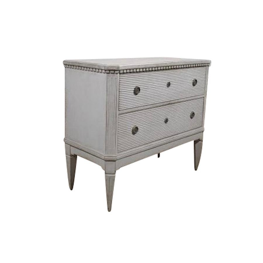 Swedish pair of Gustavian style commodes, circa 1870.
Light grey in color.
Two drawers. 
Decorative ridged trim. 
Dental molding along cornice.
Original hardware.
Newly completely restored.
Arriving April.