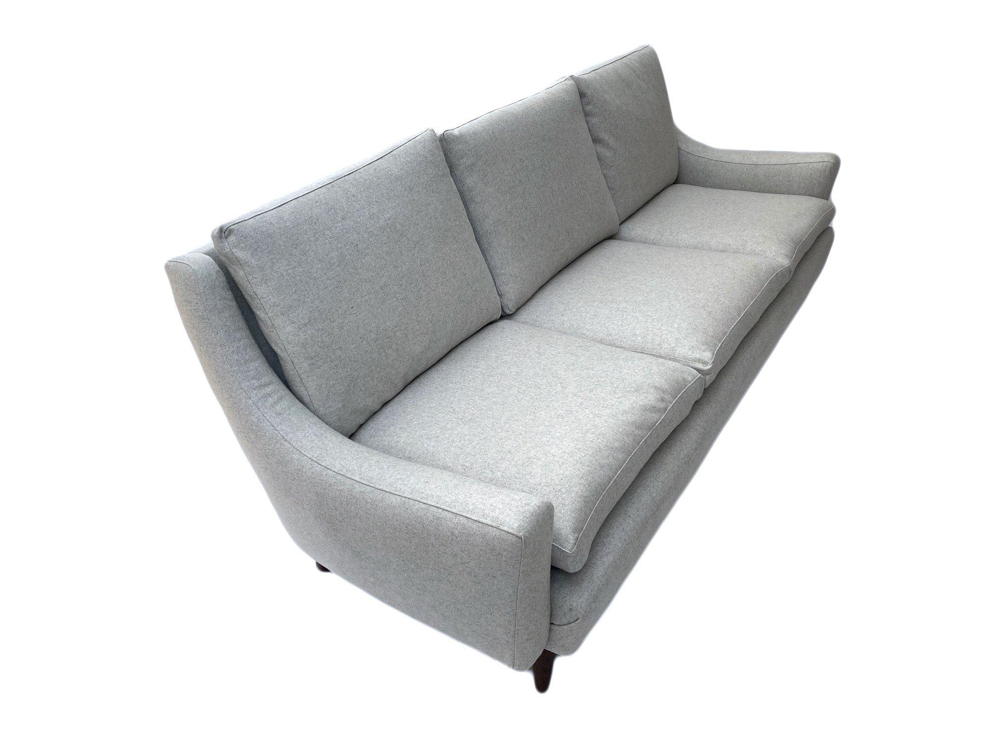 A beautiful Danish light grey wool 3 seater sofa, this would make a stylish addition to any living or work area.

The sofa has a padded armrests and feather cushions for enhanced comfort. A striking piece of classic Scandinavian furniture.

The