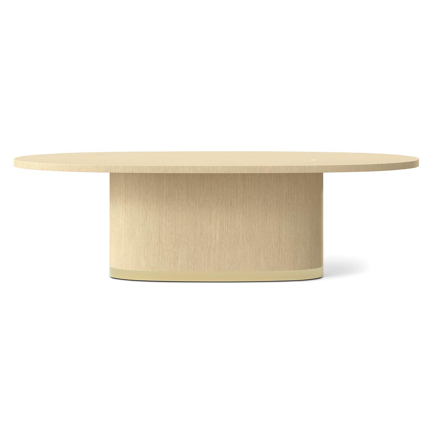A sophisticated centerpiece that blends sculptural elegance with couture-level craftsmanship. Shown in a light wood martini finish, the elongated oval top features an off-center radial sunburst veneer, punctuated by a single brass inlay at its