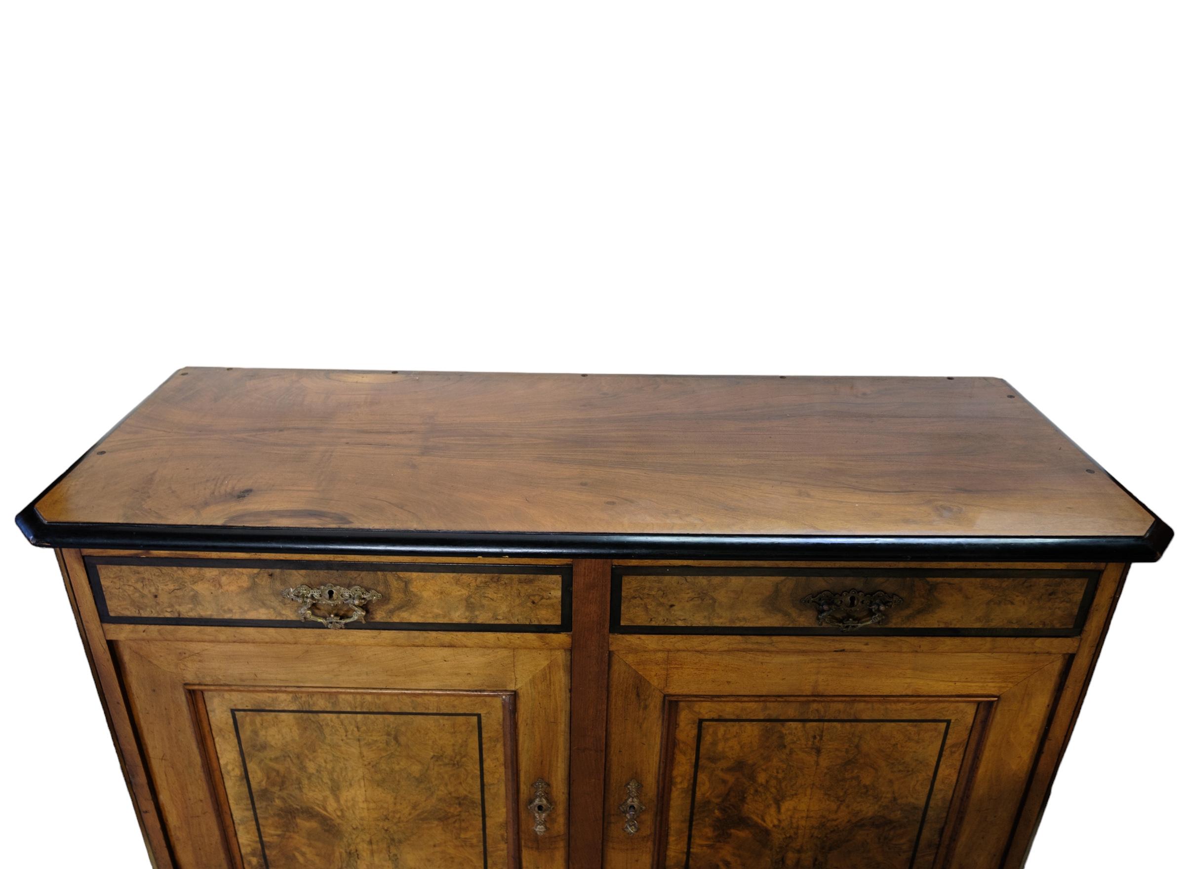 Early 20th Century Light mahogany sideboard with round legs from around the 1920s. For Sale