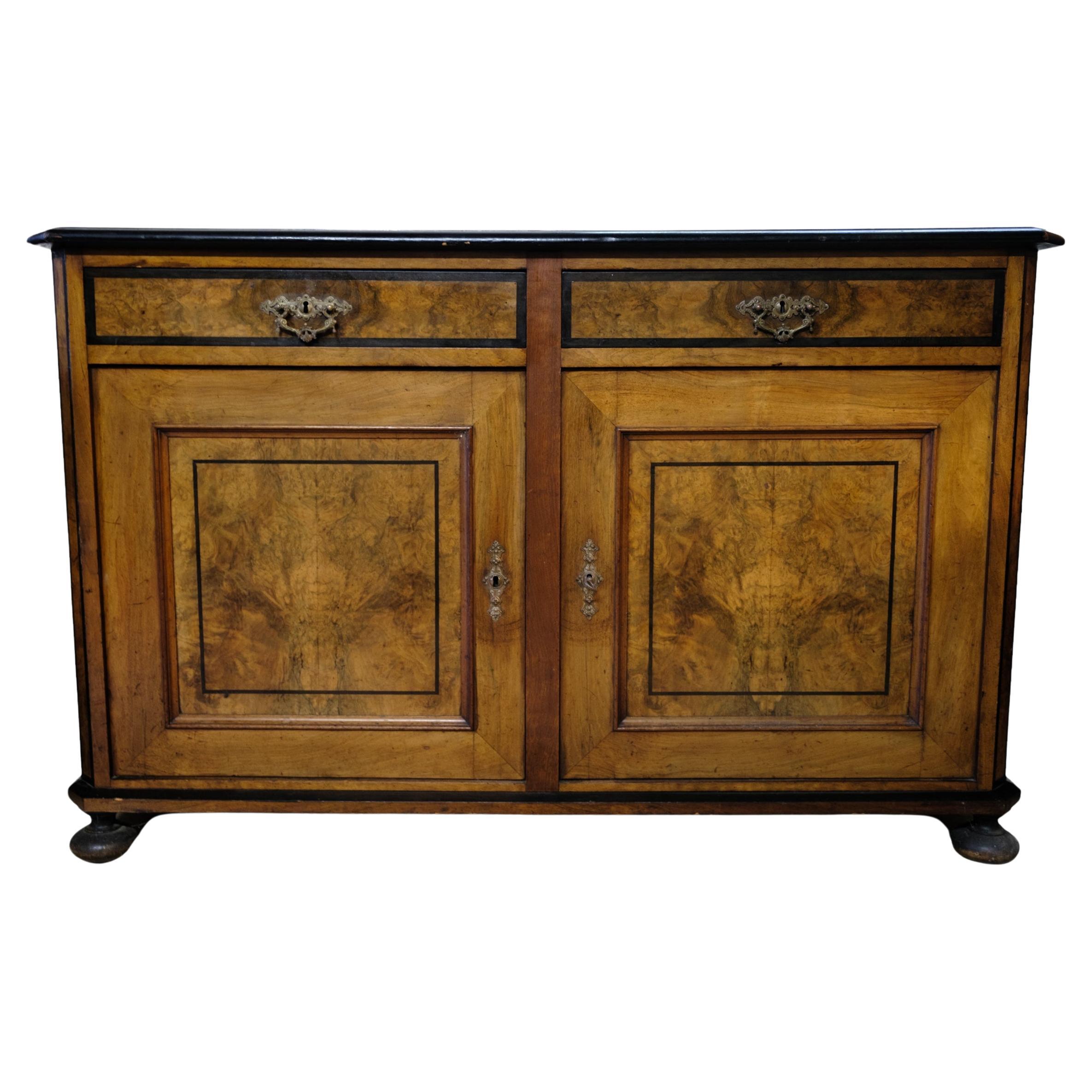 Light mahogany sideboard with round legs from around the 1920s.