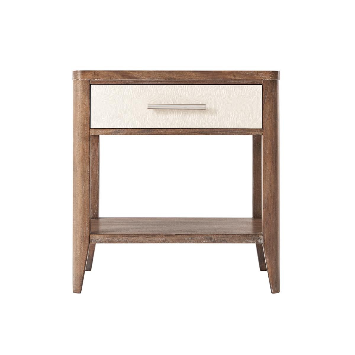 In the mangrove finish with Komodo embossed leather sides. The rectangular bedside table has a soft-closing single drawer with a brushed nickel handle, curbed corners and a lower shelf stretcher base.

Dimensions: 23.5