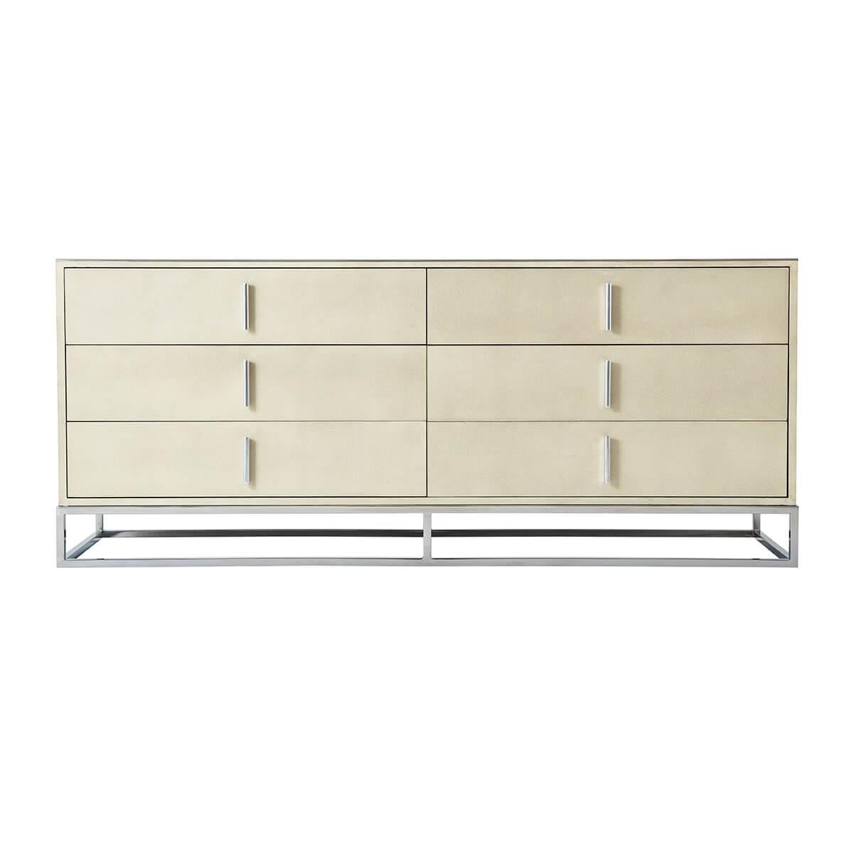 Wrapped in a shagreen embossed leather in our light overcast dove finish, with six long drawers and with polished nickel finish hardware and trim, all raised on a cube form polished nickel base.

Dimensions: 72