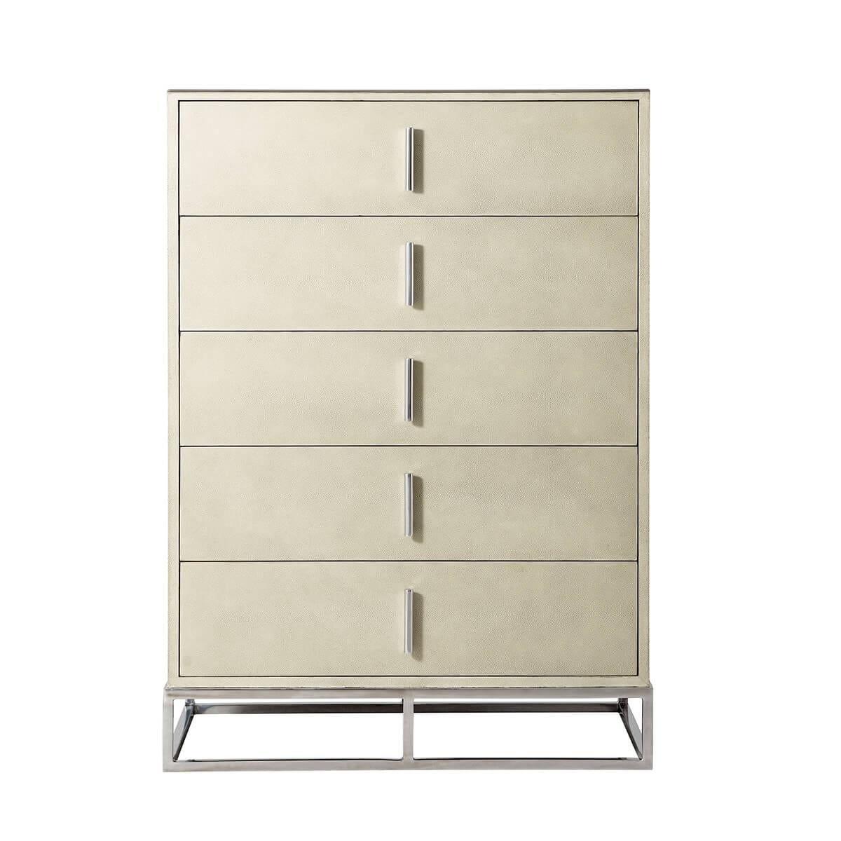 Wrapped in a shagreen embossed leather in our light overcast dove finish, with six long drawers and with polished nickel finish hardware and trim, all raised on a cube form polished nickel base.

Dimensions: 35.75