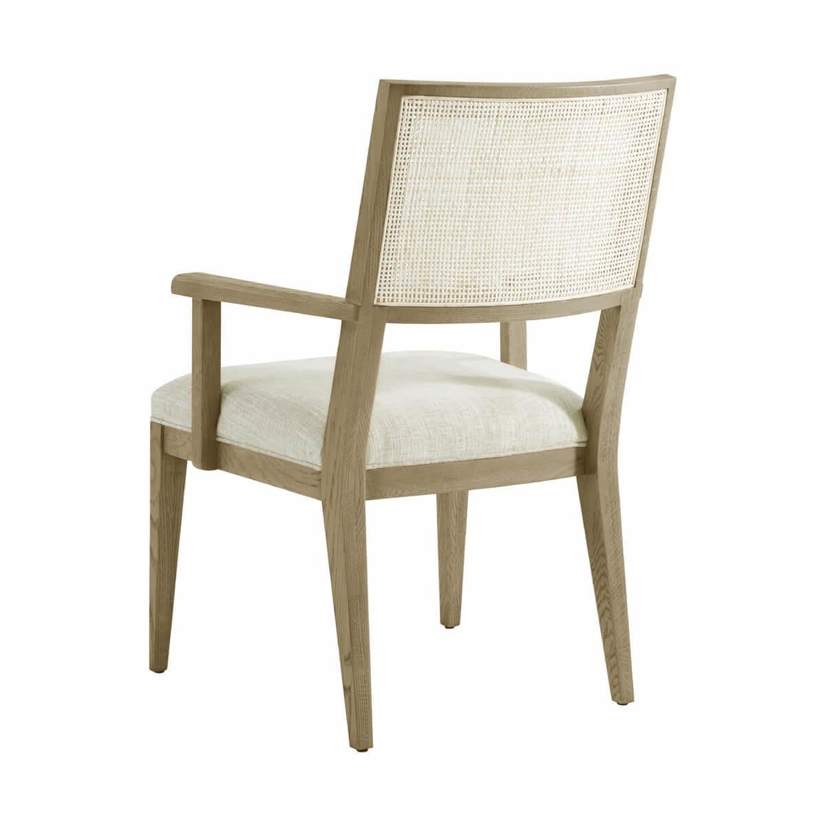 Dining Arm Chair, a solid frame in our light Dune finish, with a curved and caned backrest, a padded and upholstered seat cushions raised on tapered legs.

Dimensions: 24