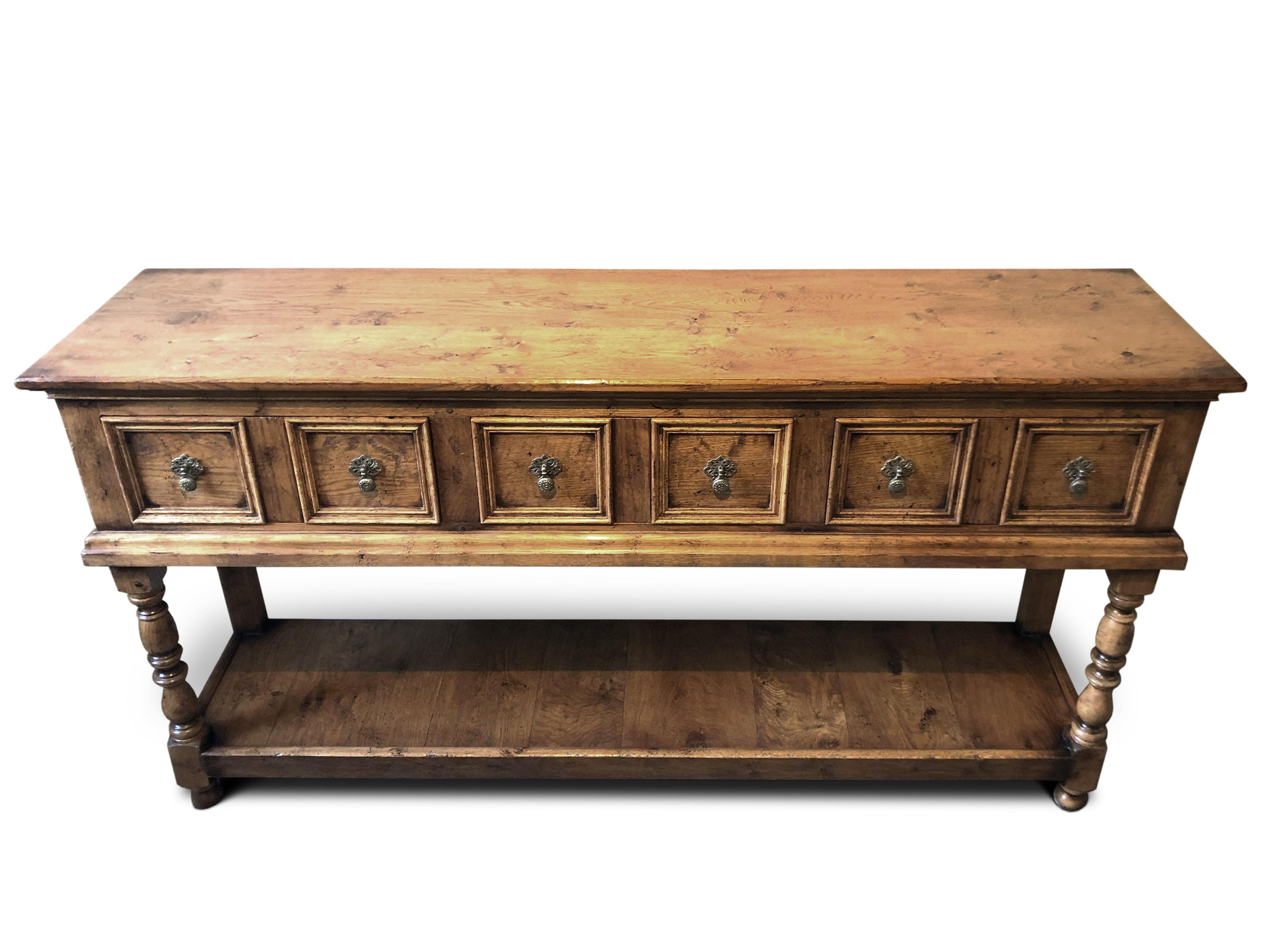 Handmade light oak dresser base.
Manufactured by Garners, Period style with lighter natural finish.
Three double fronted drawers, with pear drop handles, turned legs with potboard base.

 