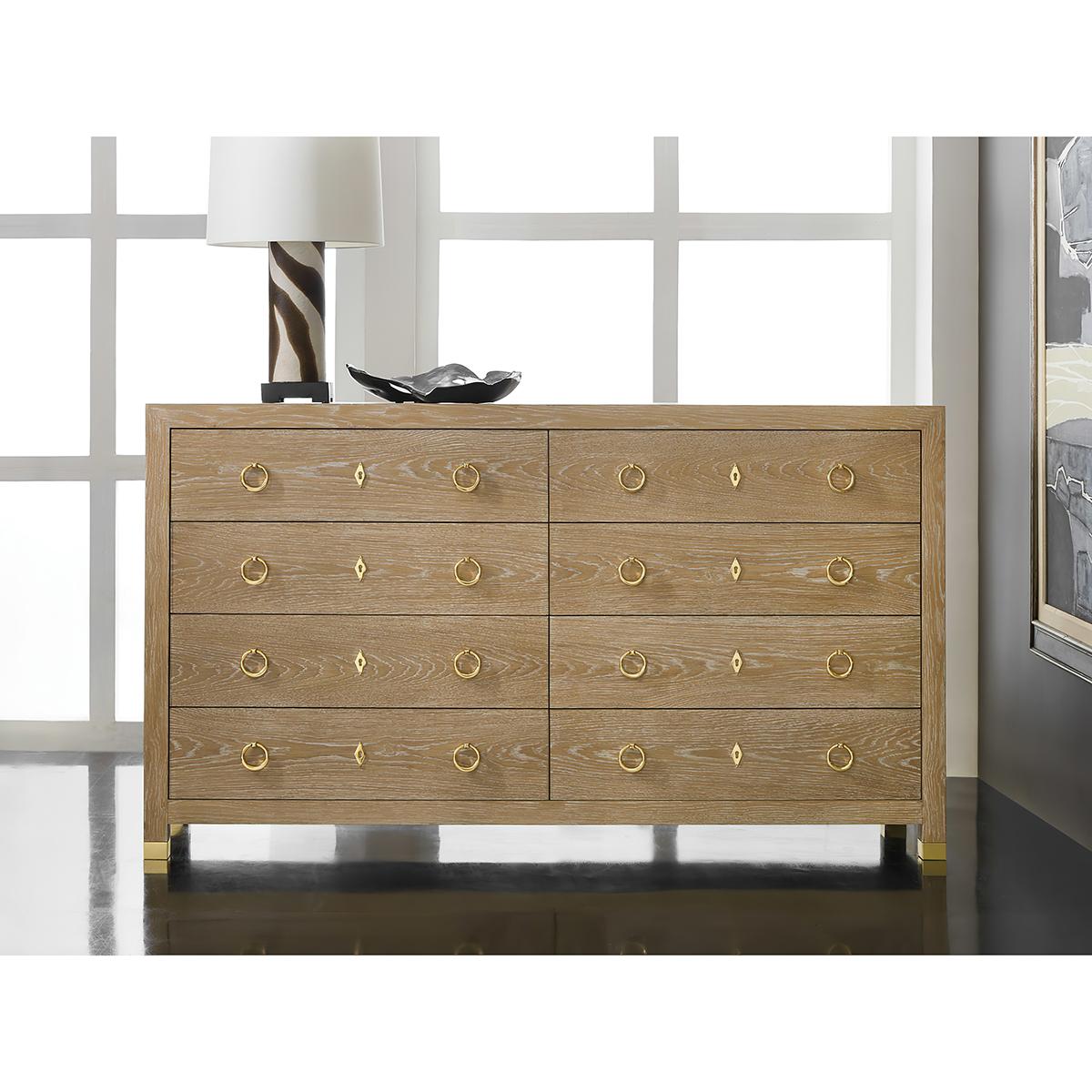 Light Oak Modern Dresser with a light whitewashed oak finish, has a simple cubist geometric form with eight drawers, each with soft closing mechanisms and polished brass ring pulls. The Square case has square brass feet. The dresser is expertly