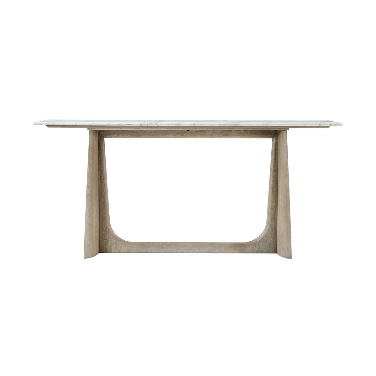 Featuring a wire-brushed white oak in our light grey oak finish. With a Volakas marble top raised on trapezoidal form trestle ends with a stretcher.

Dimensions: 72