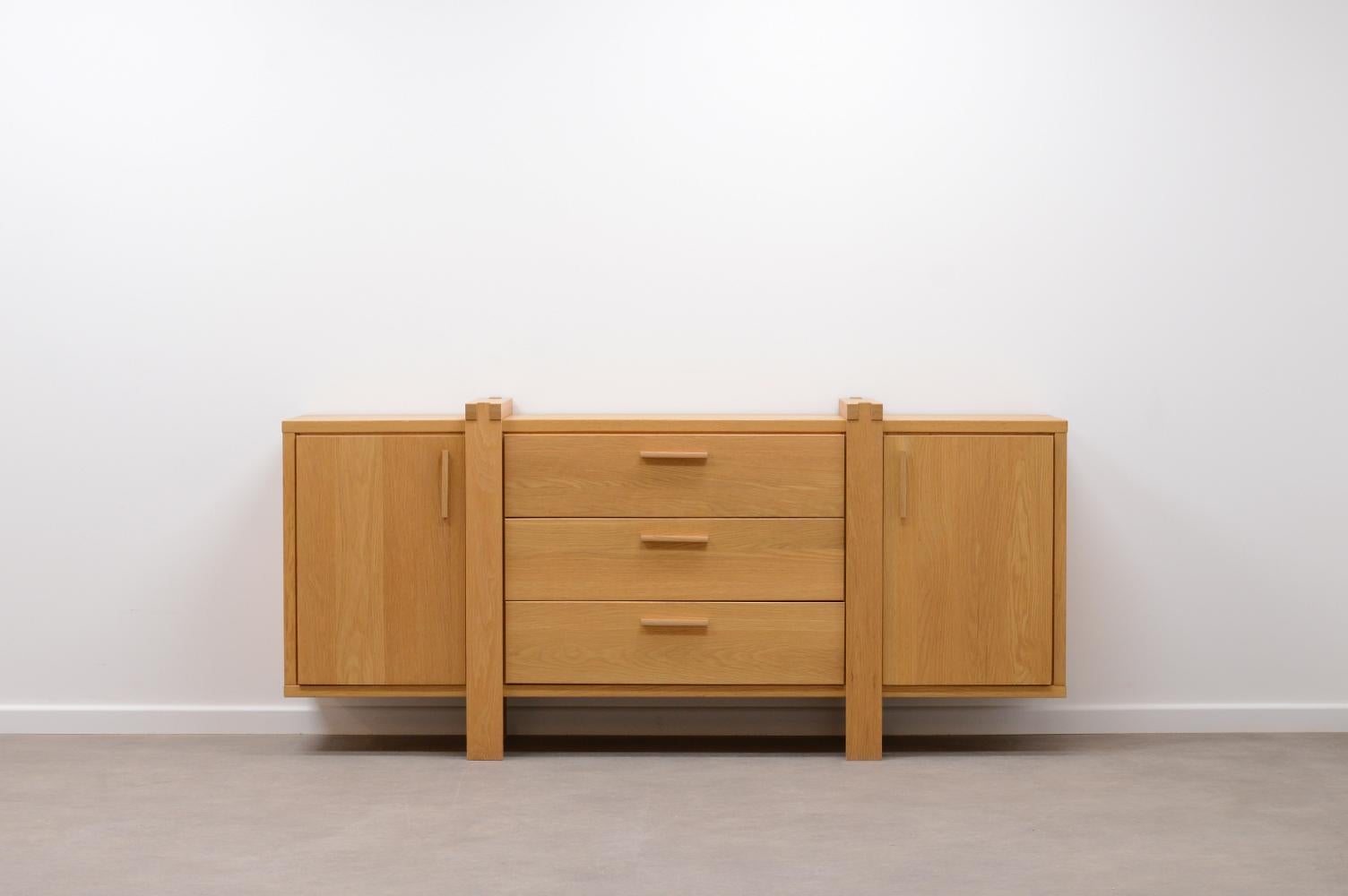 Belgium oak sideboard. Mostly made of solid oak. 3 drawers and 2 doors. Behind every door is a shelf. In very good vintag condition.

Request a quote for the latest shipping rates.