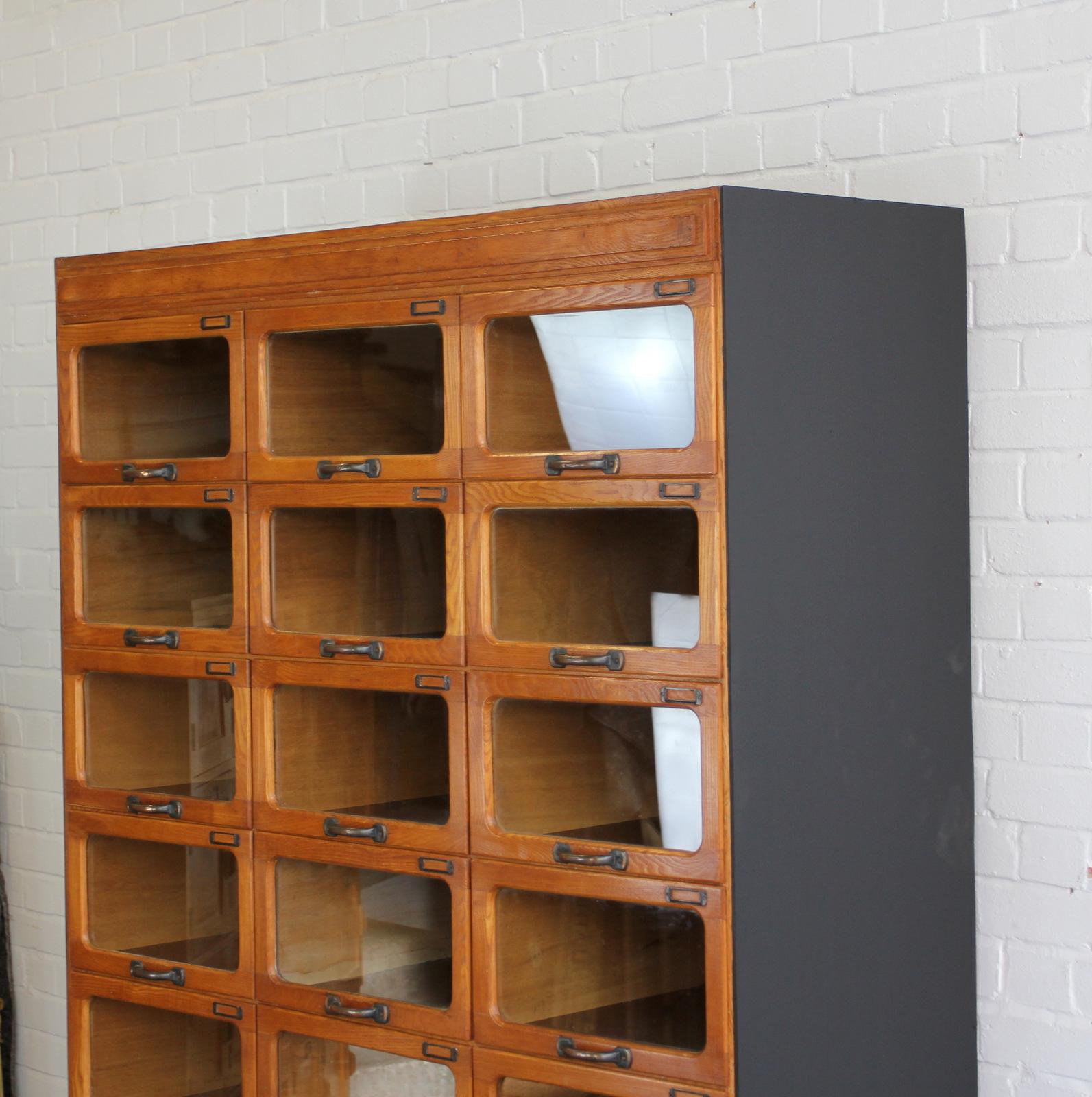 Light oak window fronted haberdashery drawers, circa 1940s

- 18 window fronted drawers
- Shelving space at the bottom
- Copper handles and card holders
- Light oak frame and drawers
- Matt black ply sides
- Originally used in a department