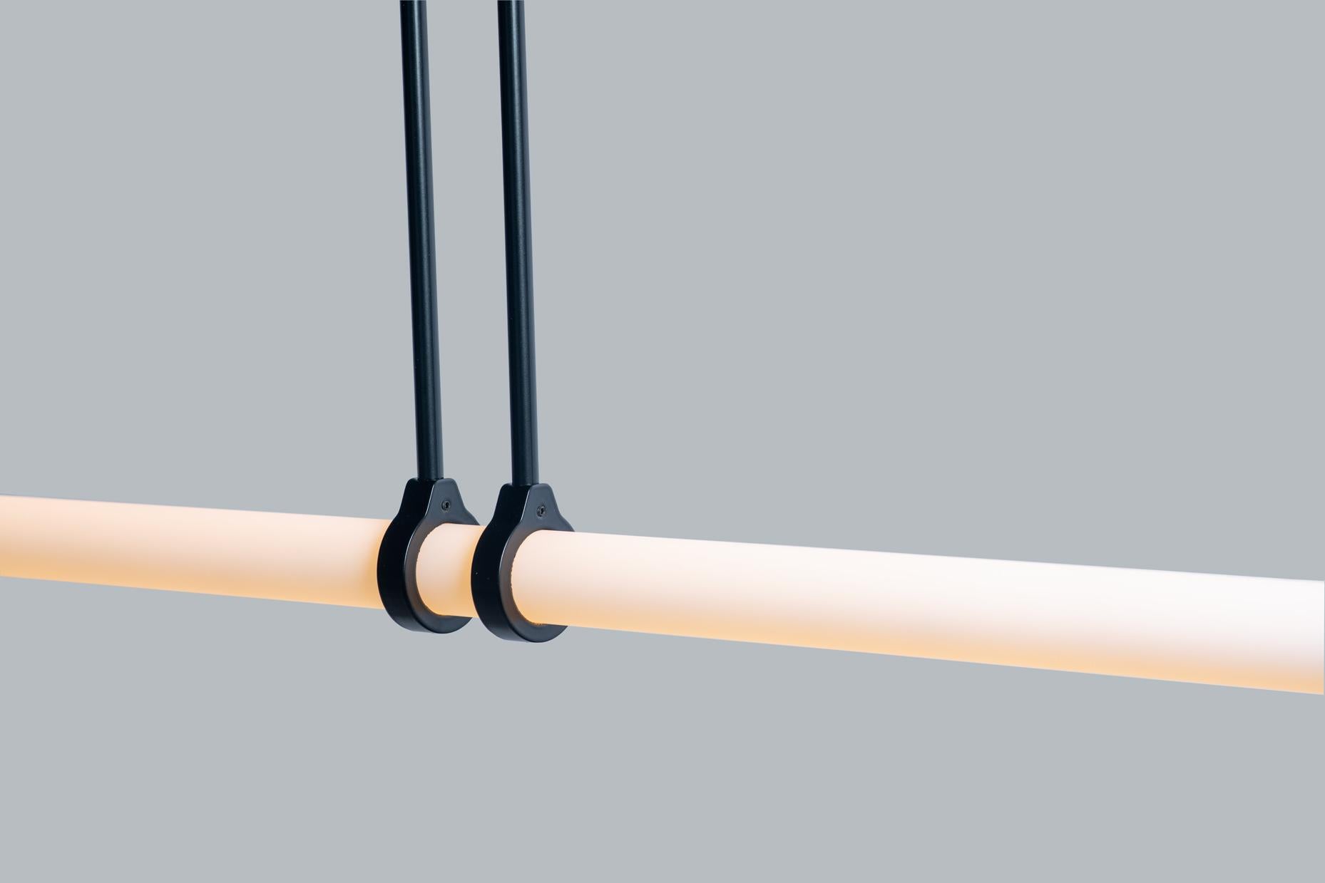 Pendant light object.
This light object emphasizes the strength of a simple line of light and how easily it can bring comfort and organize a space.

Lead time: 8 weeks
Dimensions: 81 cm x 68 cm (height to order)
Materials: brass, acrylic tube, LED
