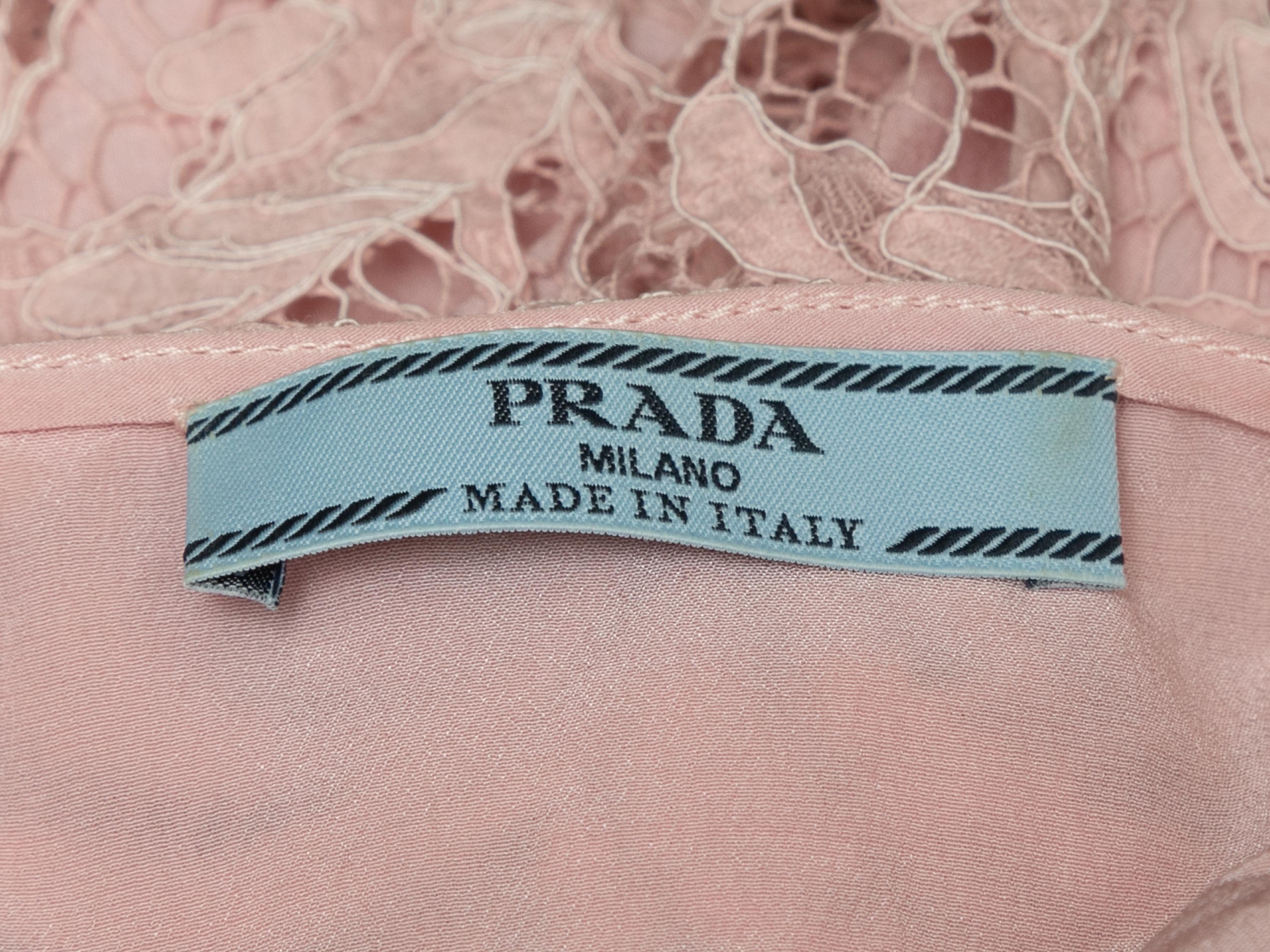 Light pink Chantilly lace sleeveless dress by Prada. Square neckline. Black grosgrain ribbon straps featuring bow tie closures. 32