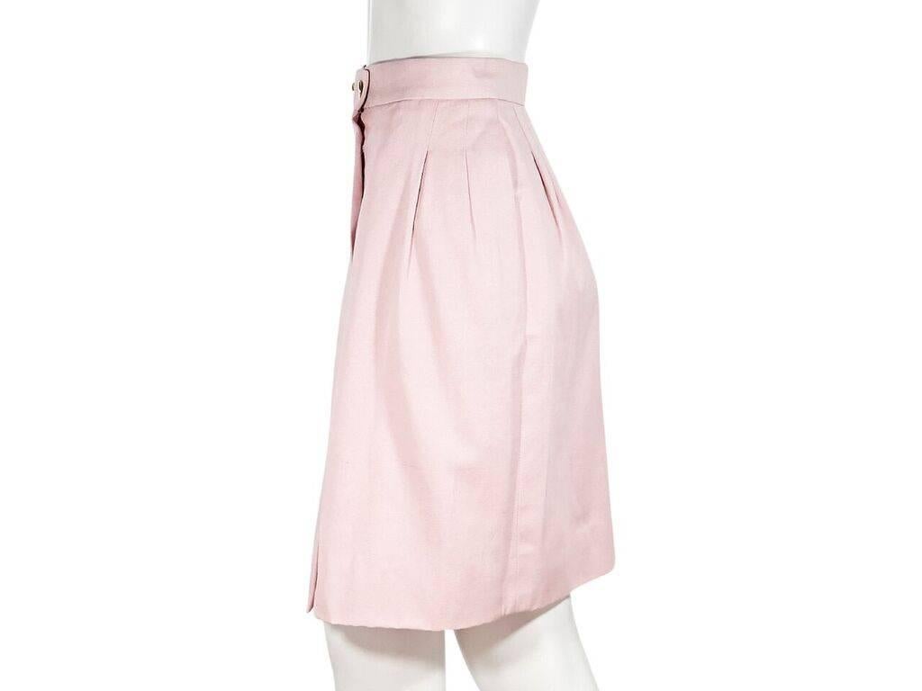 Product details:  Vintage light pink skirt by Chanel.  Banded waist with double button closure.  Pleats taper off waist for fitted style.  Goldtone hardware.  Label size FR 36.  26