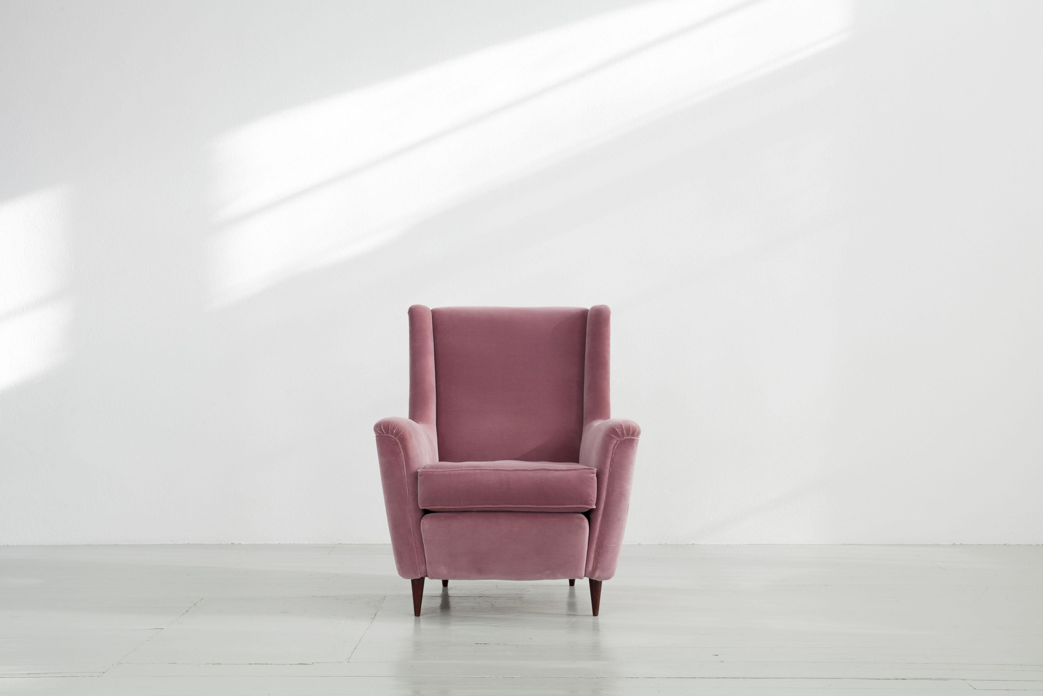 Dieser Sessel wurde 1951 in Italien von Ico Parisi entworfen und von Ariberto Colombo hergestellt. Der massive Stuhl war in ihrer Vergangenheit mit einem hellrosa Bezug neu gepolstert worden. Dieser hat einige leichte Schäden, die Sie auf den