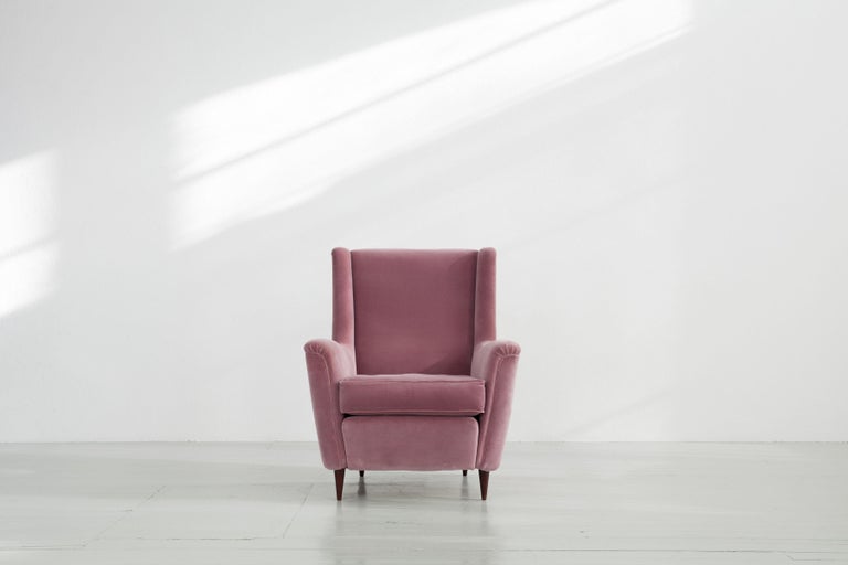 This armchair was in Italy in 1951 designed by Ico Parisi and manufactured by Ariberto Colombo. The massive chair had been re-upholstered in their past with a light rose coloured cover. This has some slight damages, which you can see on the detailed