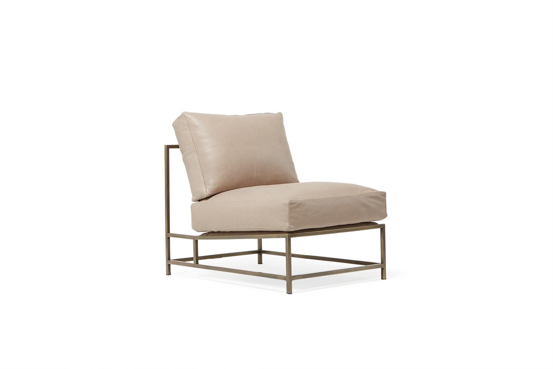Sleek and refined, the Inheritance Chair is a great addition to nearly any space.

This variation is upholstered in a creamy, light smoke colored leather. The foam seat cushions have been wrapped in down, allowing for a soft and comfortable lounge