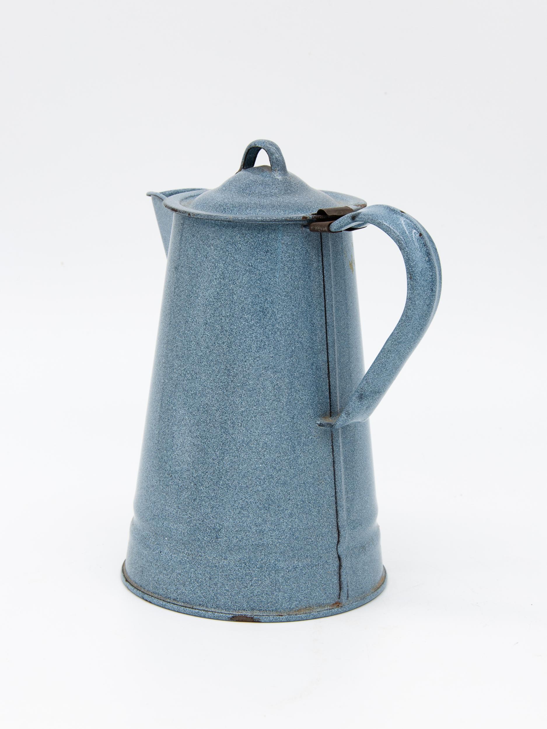 This tin pitcher has a beautiful shape and color to it, a muted speckled blue.While originally for use in the kitchen this now makes an amazingly decorative watering can. Outfitted with a matching removable lid. Some paint chipping but wear is