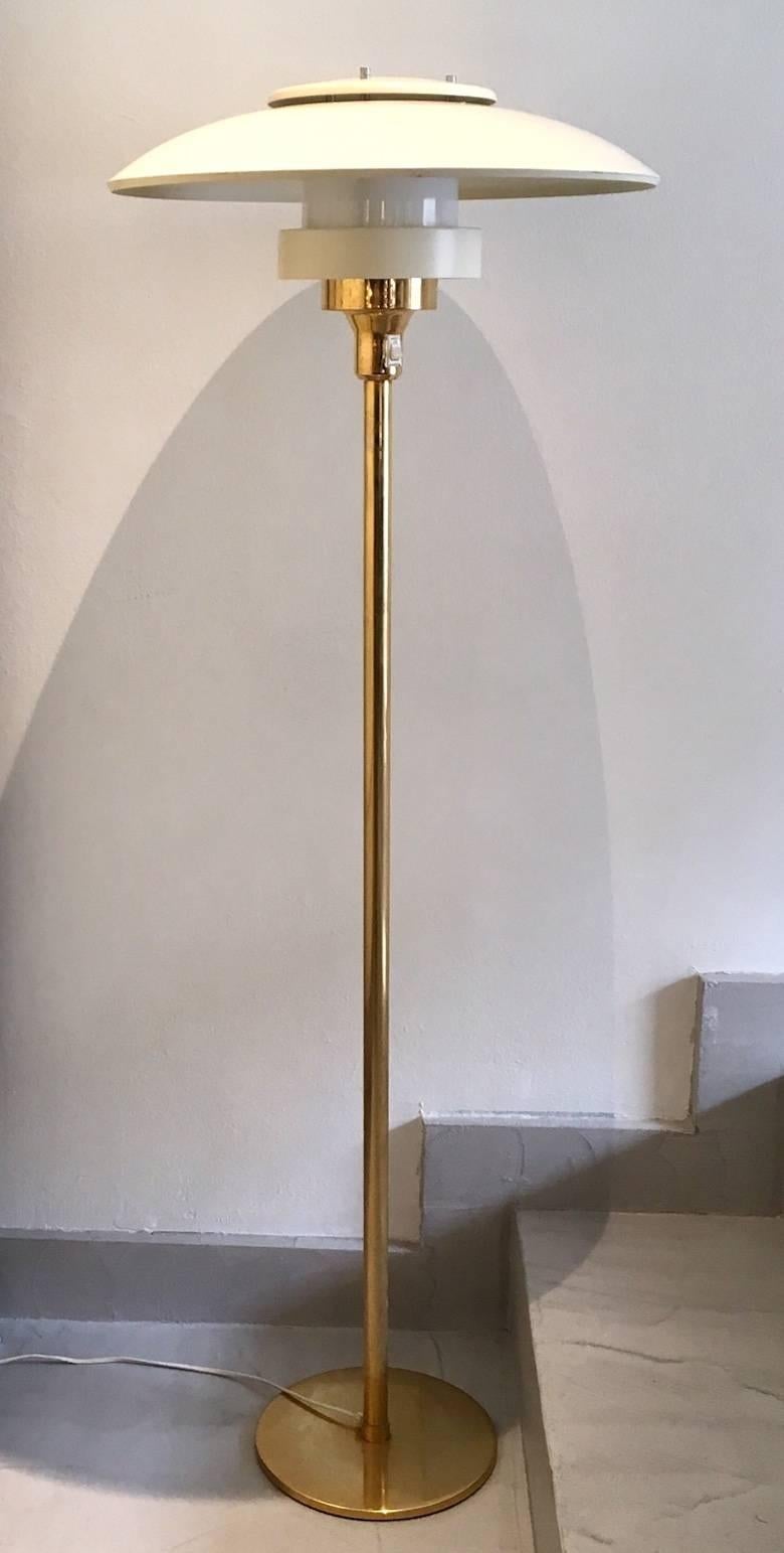 Danish floor lamp inspired by the design of Poul Henningsen's PH lamps. This one is produced by Light Studio by Horn in circa 1960s, model 1585. Lamp rod made of brass, shades of white painted metal.