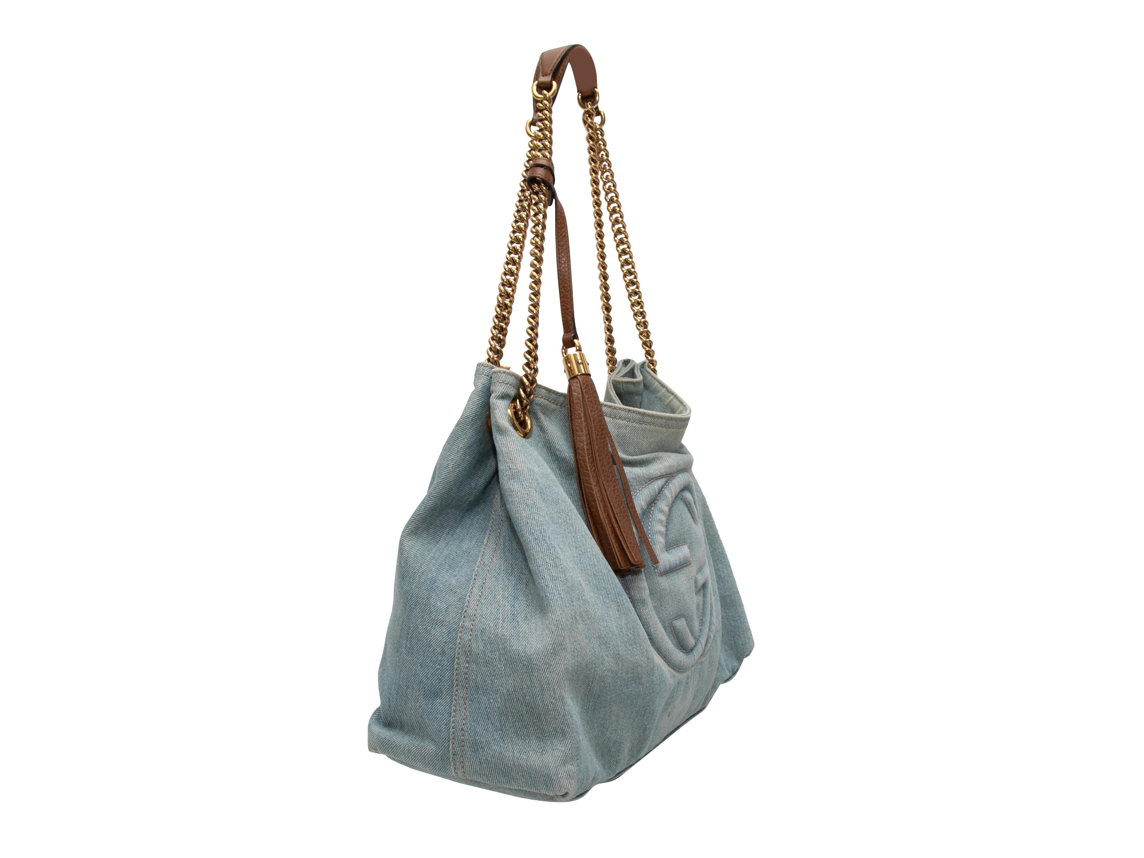 Product Details: Light Wash Gucci Denim Soho Shoulder Bag. The Soho Shoulder Bag features a denim body, leather trim, gold-tone hardware, and dual leather and chain-link shoulder straps. 13