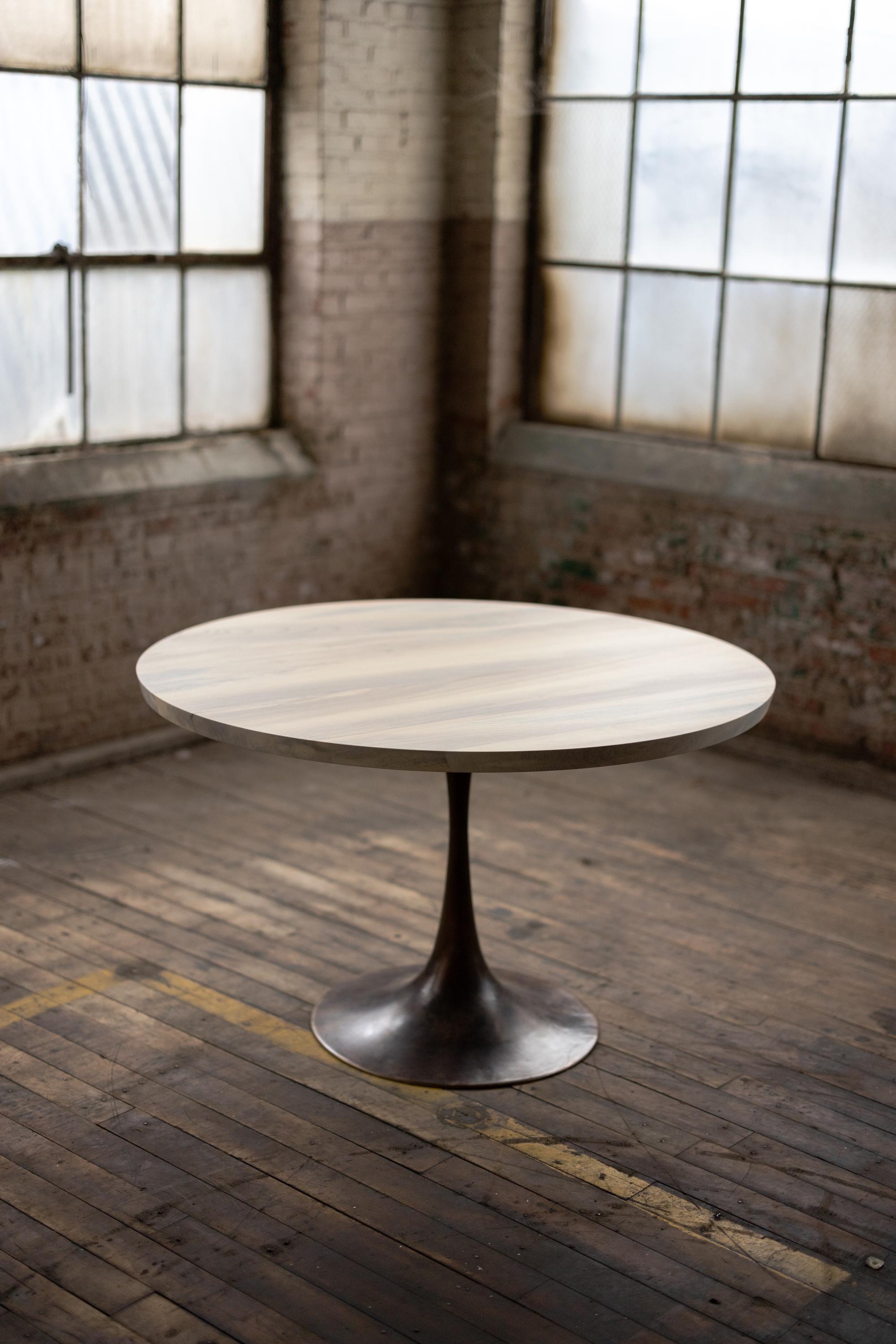 The Amicalola base captures the room set against a round or oval table top. This pedestal base is hand cast by the artisans in Birmingham, Alabama to look beautiful and function out of the way of diner's feet. Rich with Mid-Century Modern