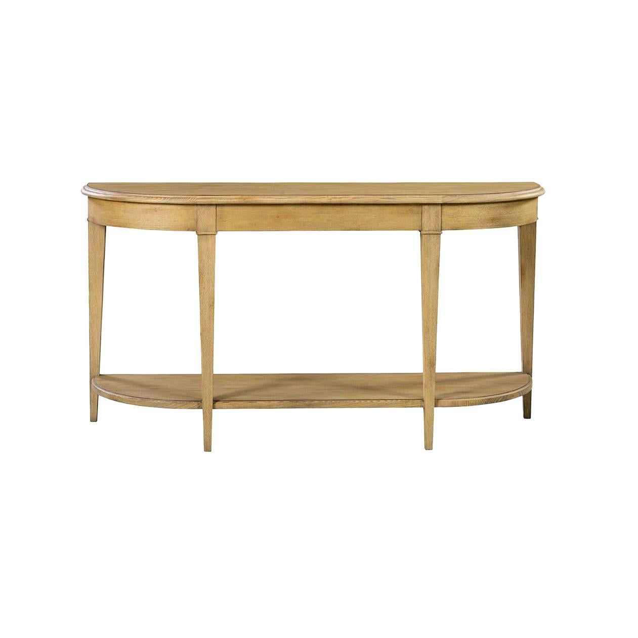 The demi-lune silhouette is accentuated by a molded edge top and apron, showcasing graceful curves with classical inspiration. Square tapered legs support the design while the integrated stretcher shelf offers practical storage and balance to the