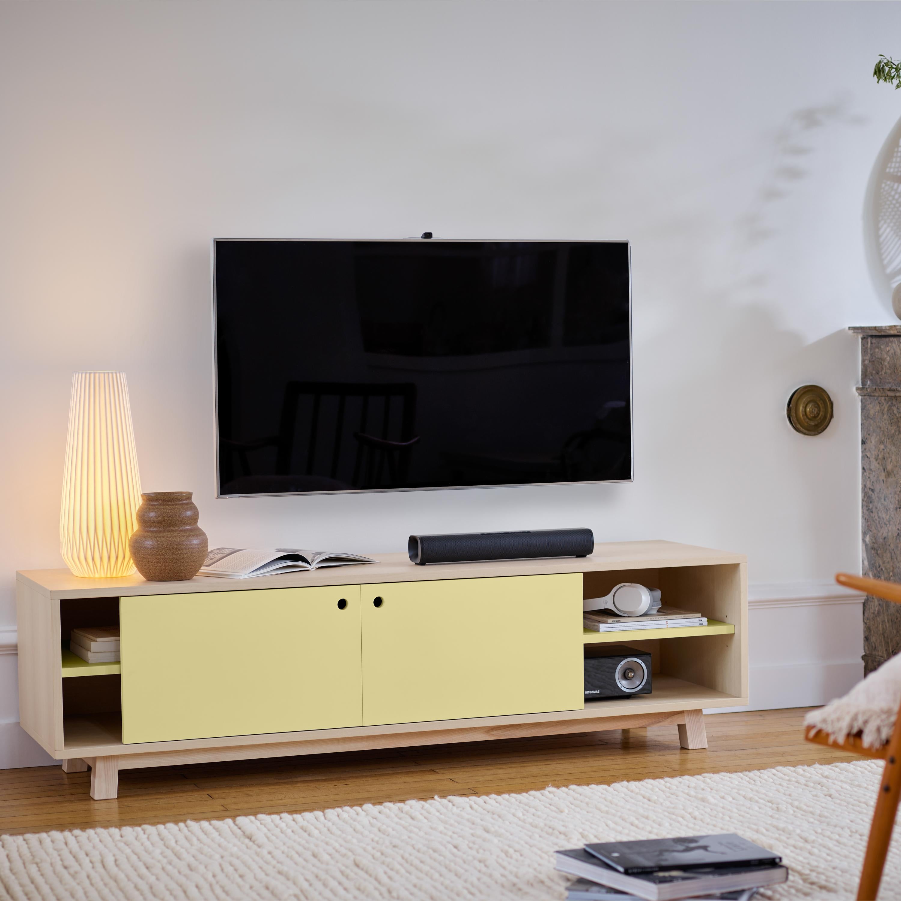 This TV stand with 2 sliding doors is designed by Eric Gizard - Paris.

It is 100% made in France with solid and veneer ash and lacquered MDF doors. 

To pull the door, use the round eyelet. 
2 adjustable wooden shelves on cleats are placed behind