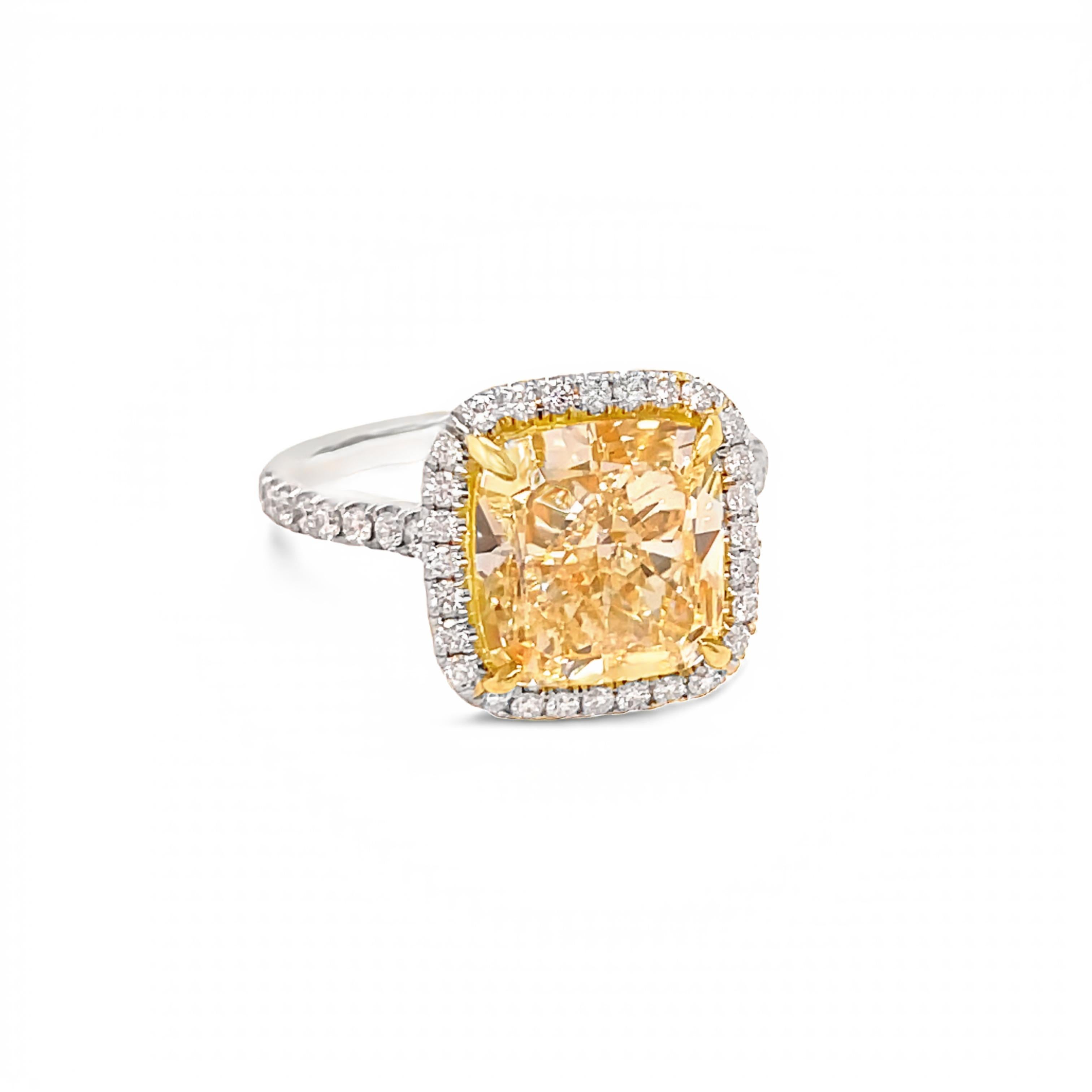 This beautiful, GIA certified, cushion cut diamond ring is 5.54 carats total. The center diamond is 5.02 carat. The GIA describes it as W-X color and VS2 clarity. Many call a diamond of this color, very light yellow.  

The ring is made in 18 karat