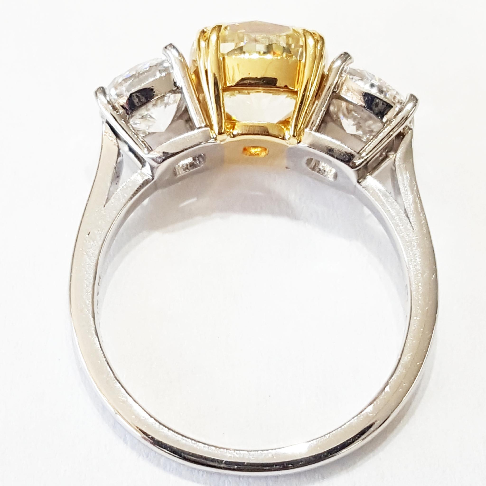Light Yellow Diamond Three-Stone Platinum Ring In Excellent Condition For Sale In Lake Forest, IL