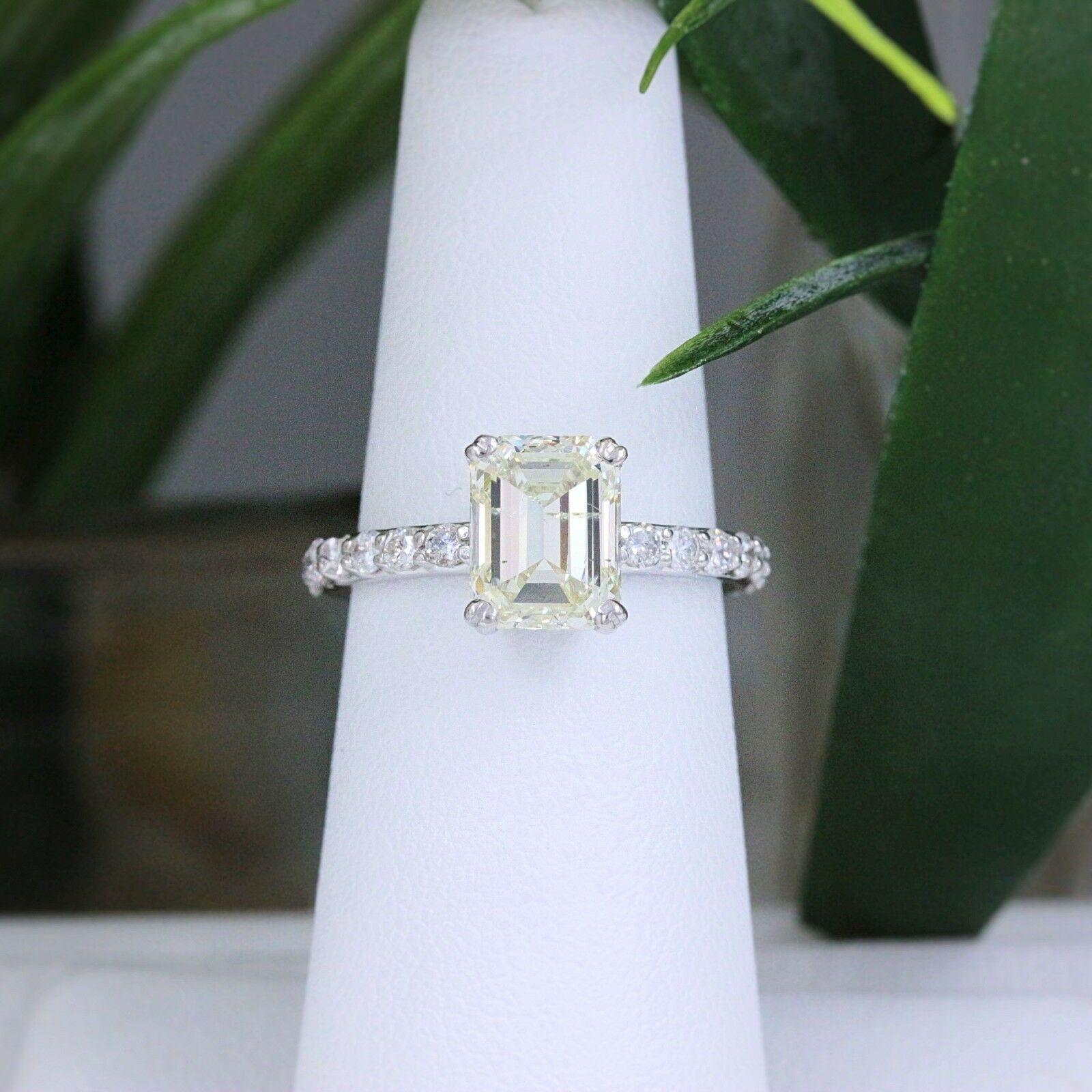 Light Yellow Emerald Diamond with Diamond Band Engagement Ring
Style:  Solitaire with Diamond Accents
Metal:  14k White Gold
Size:  6 - sizable
Total Carat Weight:  2.53 tcw
Diamond Shape:  Emerald Cut Diamond 2.05 cts Light Yellow color, SI2