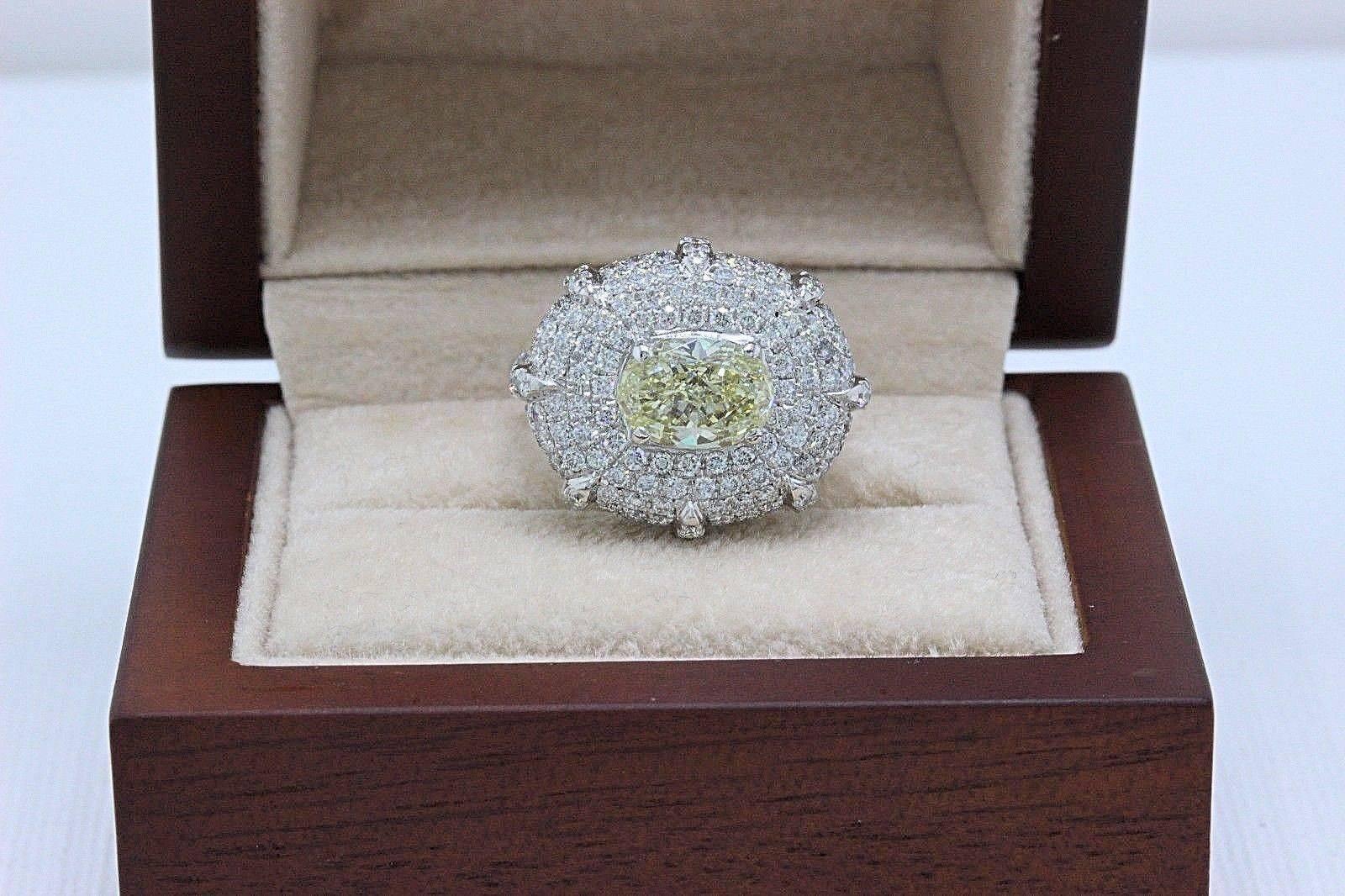 Light Yellow Oval Diamond Engagement Ring 
Style:  Pave Diamonds With Solitaire
Metal:  18KT Yellow Gold
Size:  4.75 - Sizable
Total Carat Weight:  4.24 TCW
Diamond Shape:  Oval 1.74 CTS
Diamond Color & Clarity:  Light Yellow / VS2 - SI1
Accent