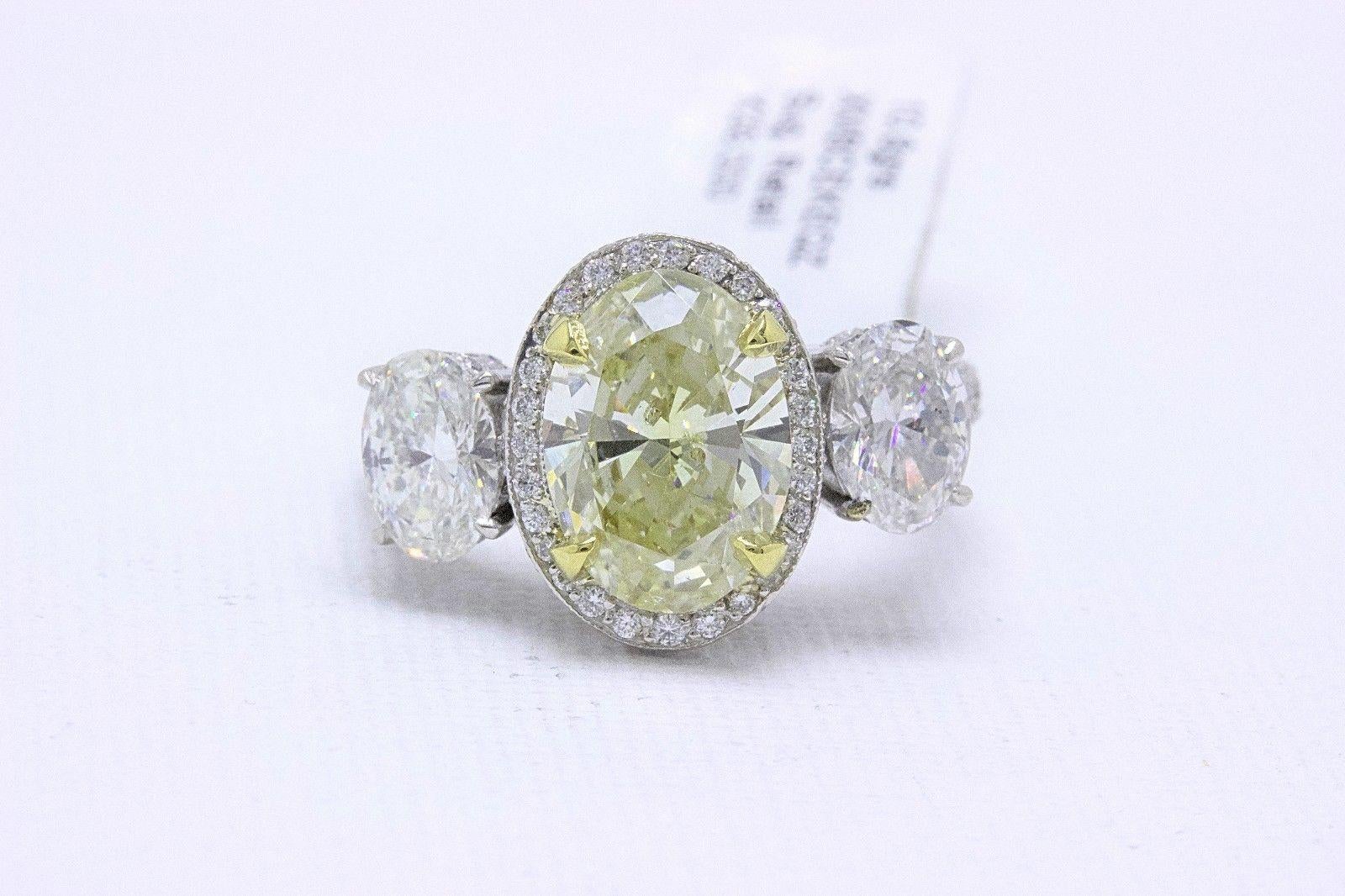 Light Yellow Oval Diamond Three-Stone Engagement Ring 6.44 Carat SI2 in Platinum 7