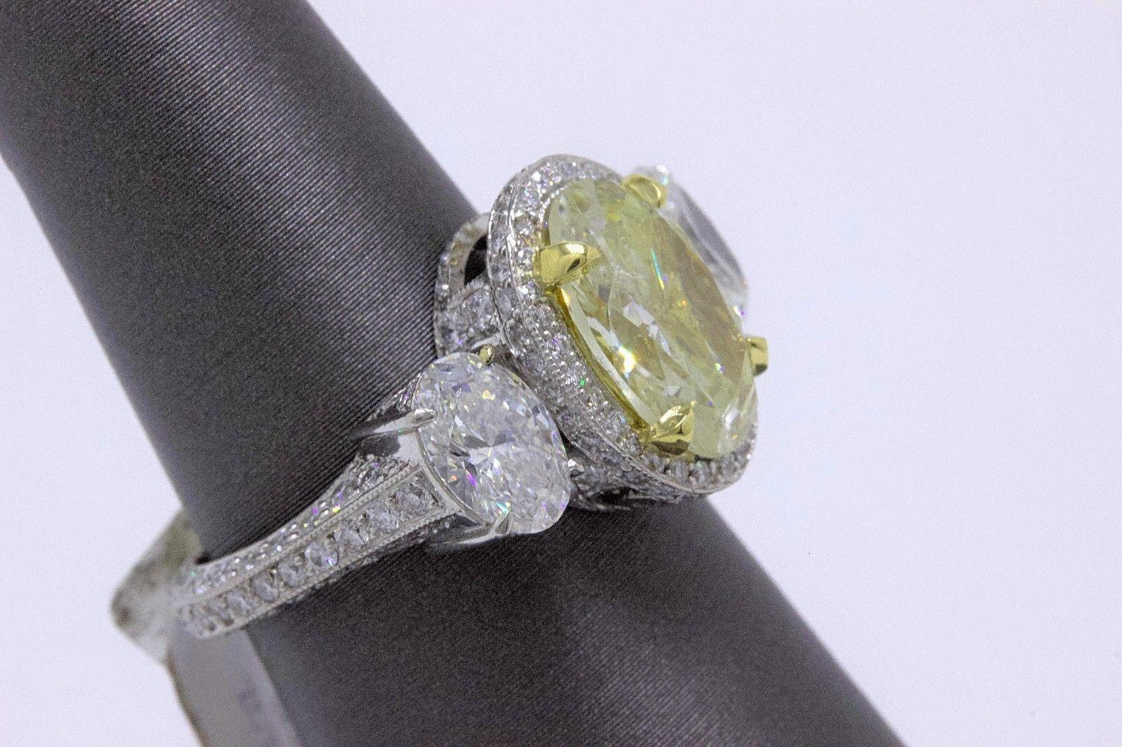 Light Yellow Oval Diamond Three-Stone Engagement Ring 6.44 Carat SI2 in Platinum In Excellent Condition In San Diego, CA