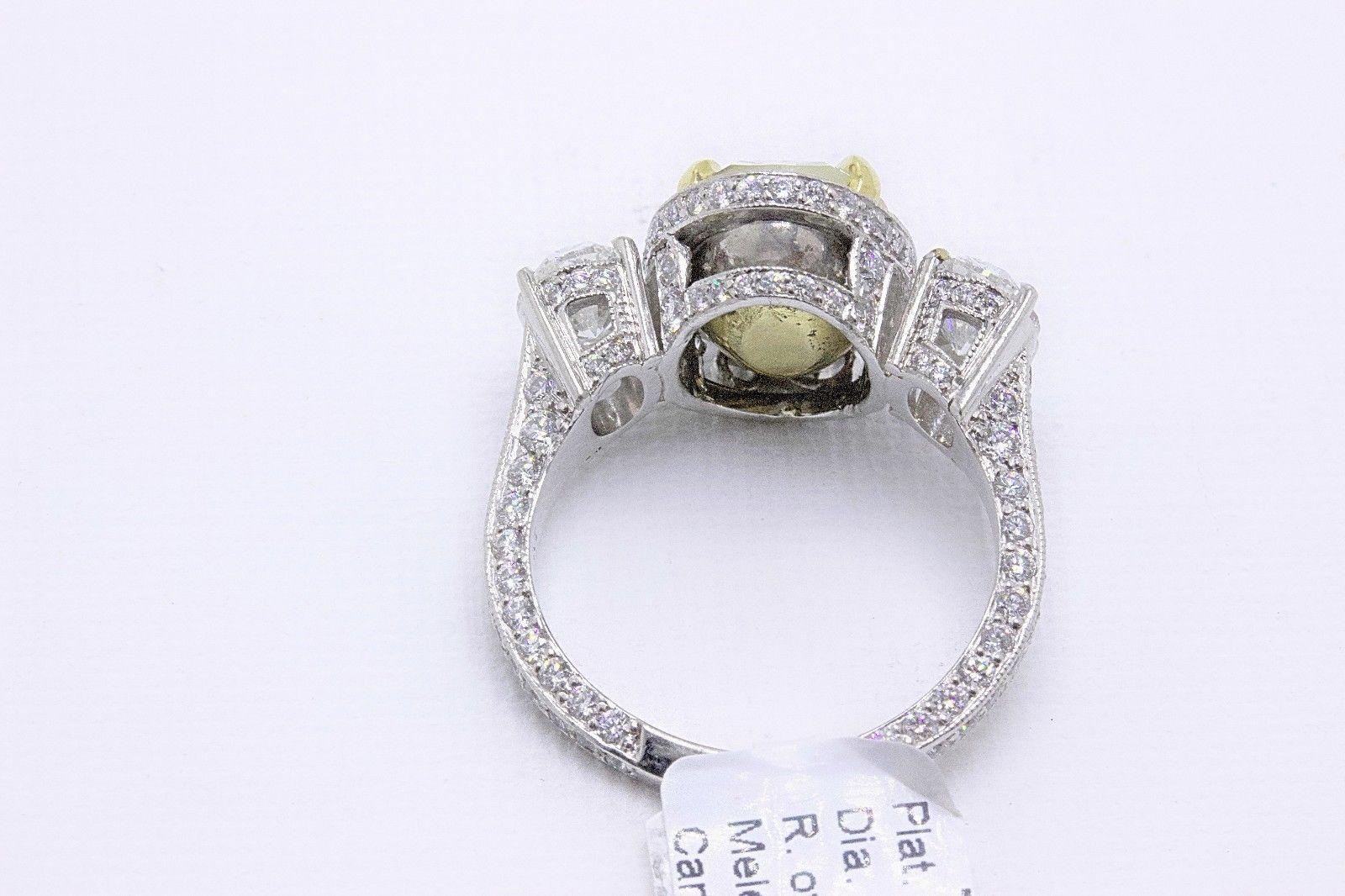 Women's Light Yellow Oval Diamond Three-Stone Engagement Ring 6.44 Carat SI2 in Platinum