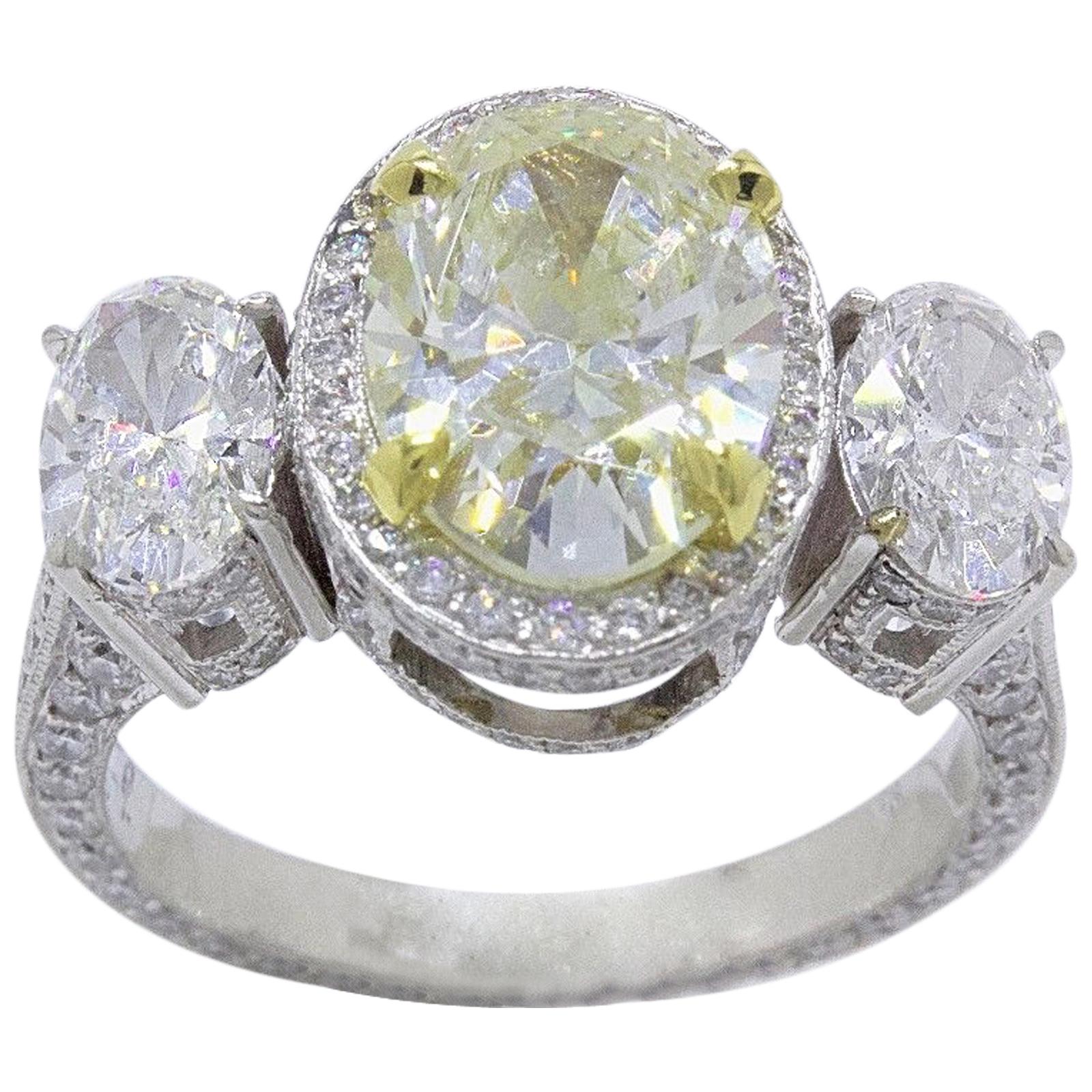 Light Yellow Oval Diamond Three-Stone Engagement Ring 6.44 Carat SI2 in Platinum