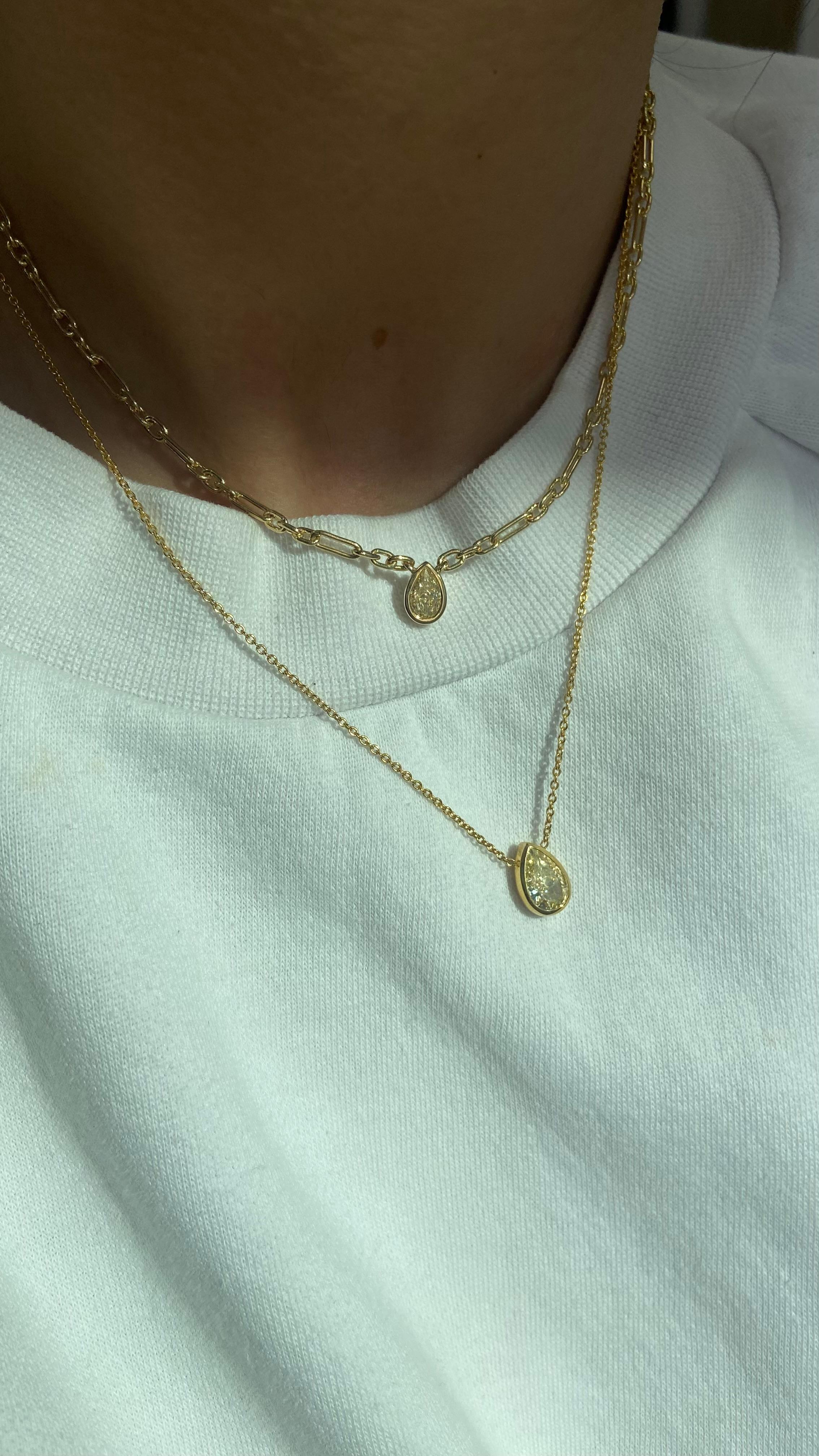 0.70 Carat 
Pear Shape Diamond
Light Yellow
VS+ Clarity 
18k Yellow Solid Gold Chain
16 Inches
Gold Bezel Setting
Handmade in NYC 

This piece can be viewed before purchase in our showroom in NYC, or at one of our retail partners throughout the