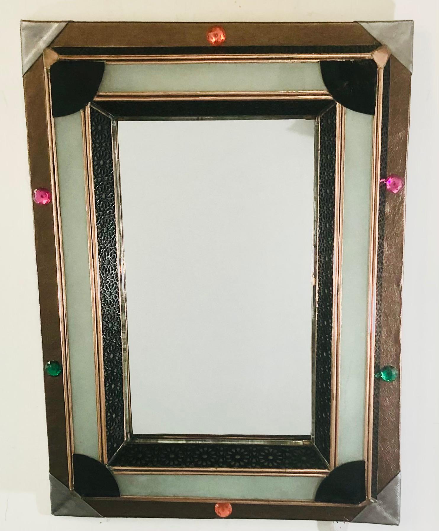 Lighted Art Deco Style Vanity Mirror or Wall Mirror
A delightful vanity or wall mirror featuring multicolored buttons and a faux leather frame. The mirror has a lighted milk glass frame that is wired. The faux leather shows beautiful geometrical