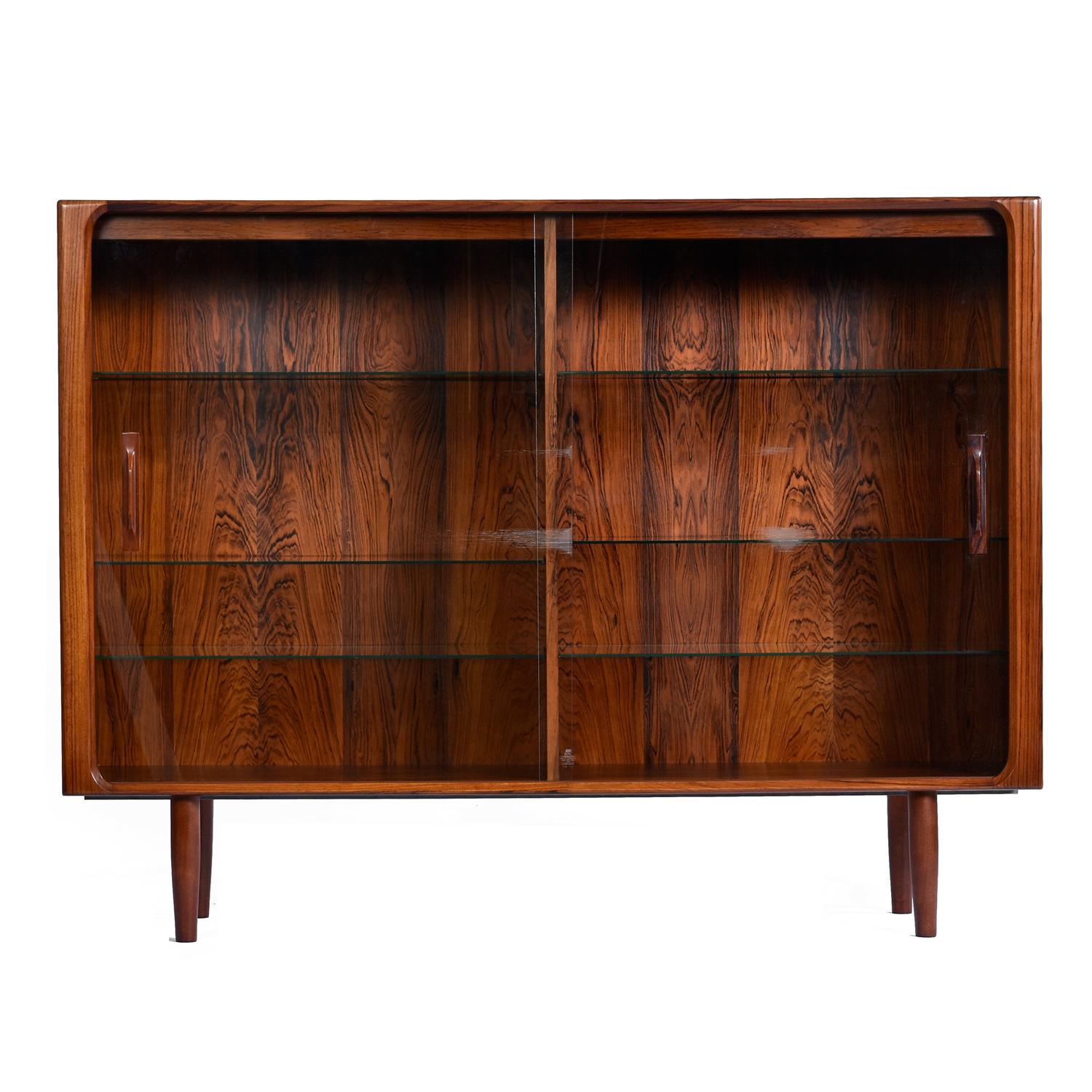 Illuminated from the interior, this Scandinavian display cabinet glows with elegance.  Ideal as a dry bar or bookcase, this vintage, mid-century Scandinavian Modern Danish teak hutch is truly one of a kind.  Our restoration team elevated this hutch