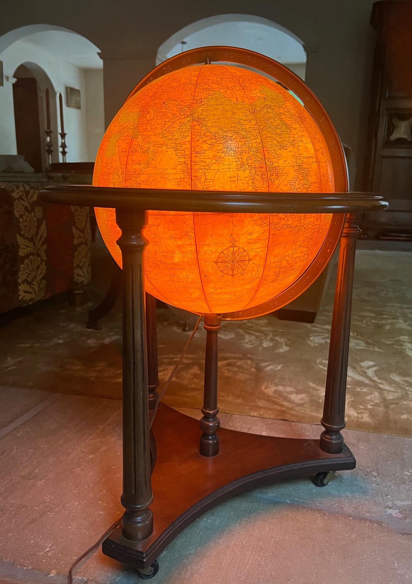 Sixteen inch Replogle Heirloom Globe light on a wooden stand with casters, made in the USA in the 1970's.

