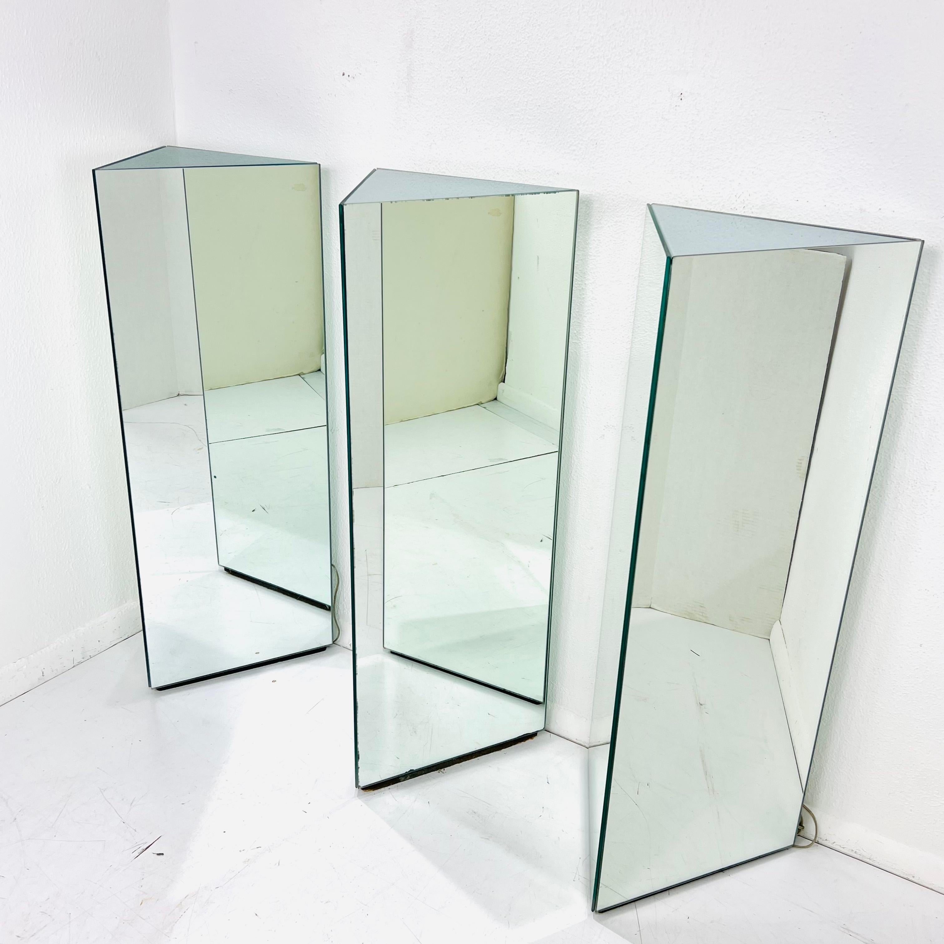 Custom made 1980s lighted triangular mirrored pedestals. Each mirrored side measures 16