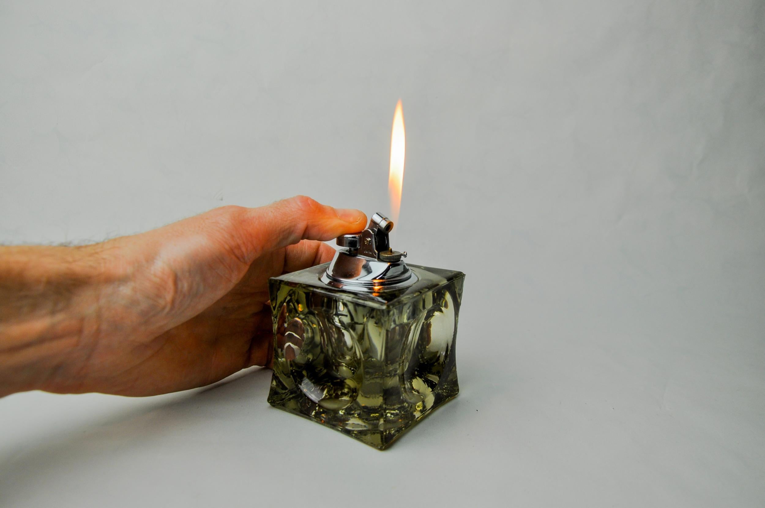 Superb and rare magnifying lighter designed and produced by Antonio Imperatore in Italy in the 1970s. Black Murano glass lighter with a magnifying effect on its facets, handcrafted by Venetian master glassmakers. Decorative object that will bring a
