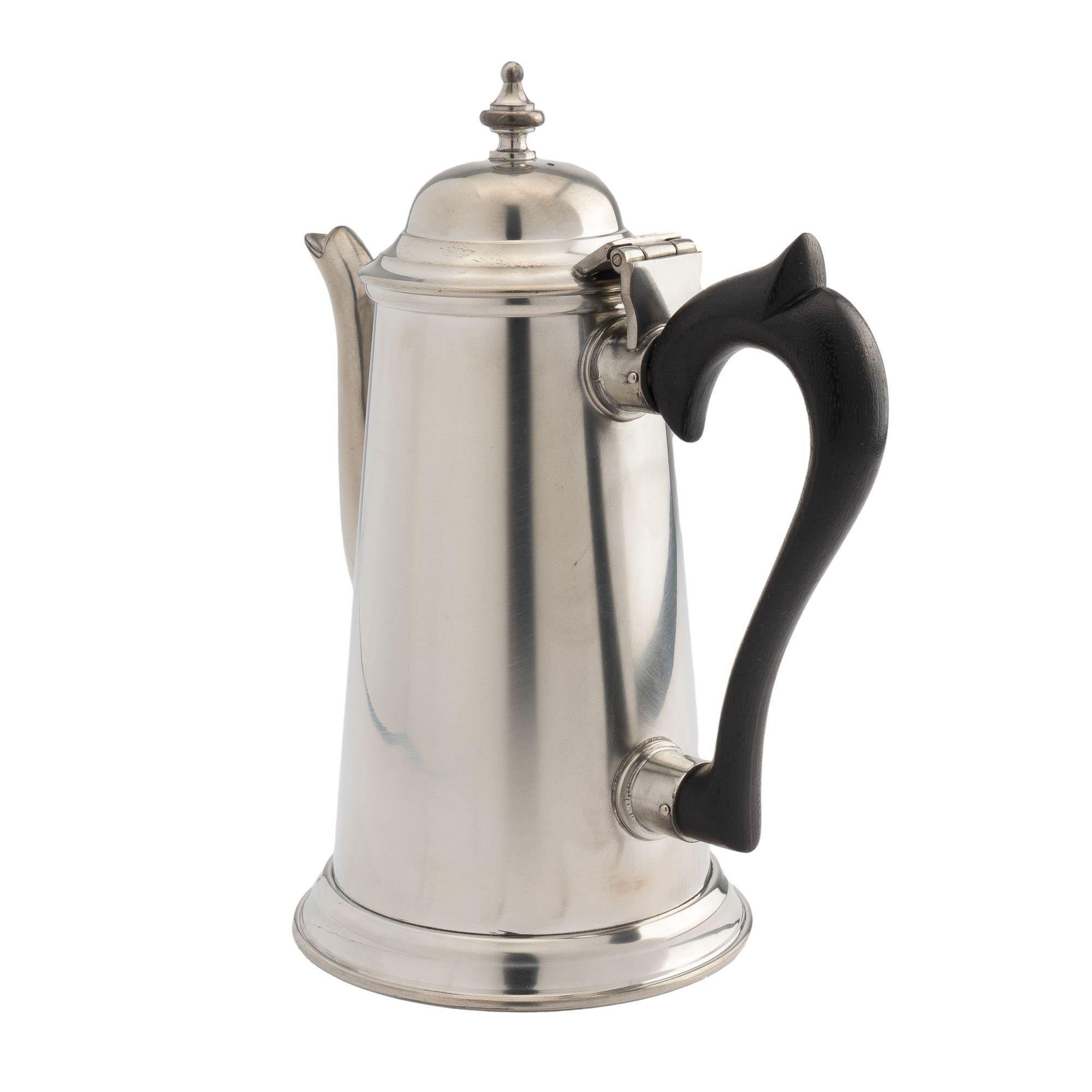 Academic Revival lighthouse form pewter coffee pot with hinged lid and carved wooden handle. Maker's stamp on the underside.
American, Baltimore, Maryland, 1979.